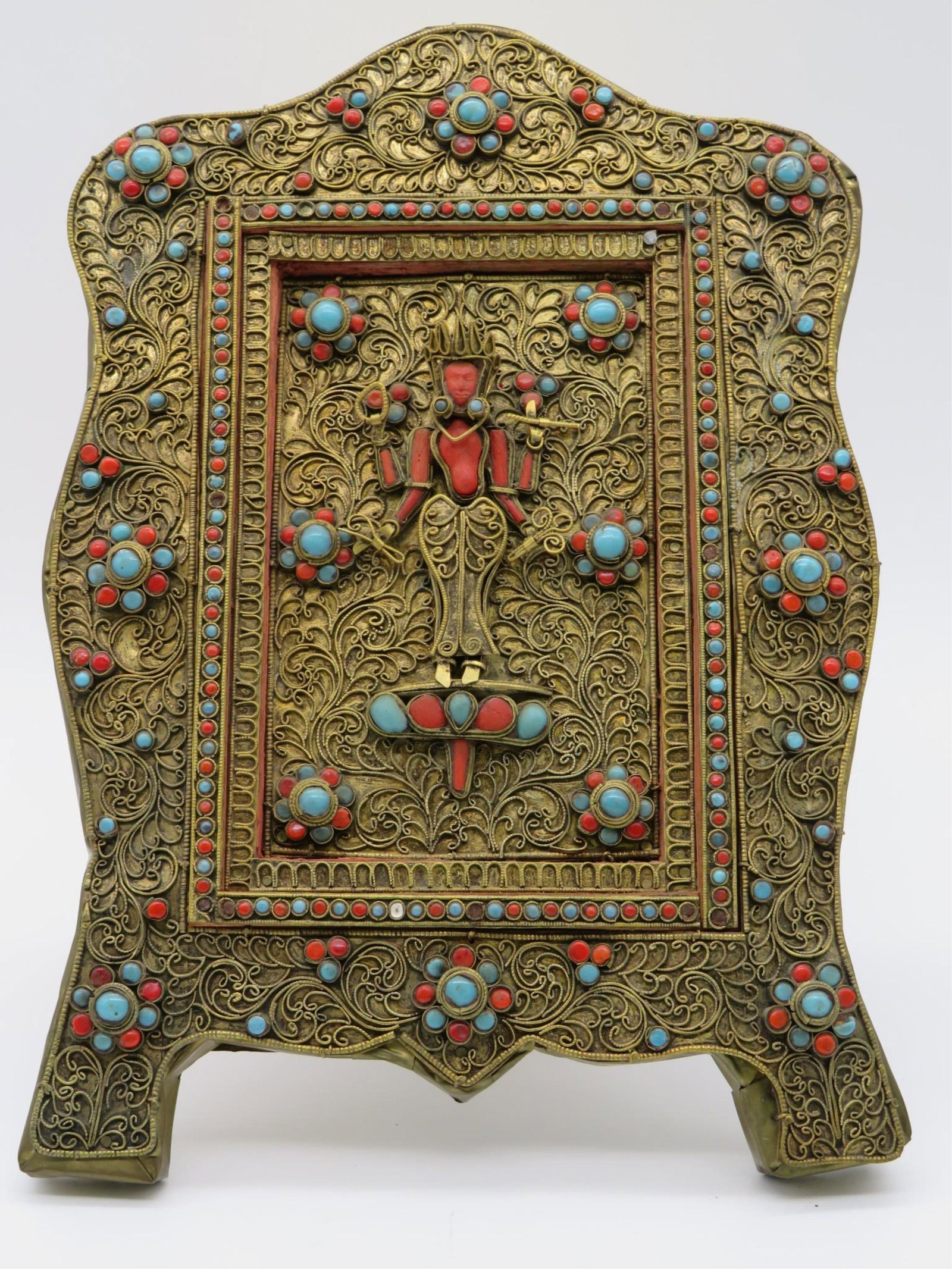 Nepalese Gilt-Metal & Stone Votive Plaque: Antique Nepalese Gilt-Metal Filigree and Inset Stone Votive Plaque. The center a bodhisattva inset and surrounded by coral and turquoise cabochon stones with filigree work throughout. Unmarked. Good c