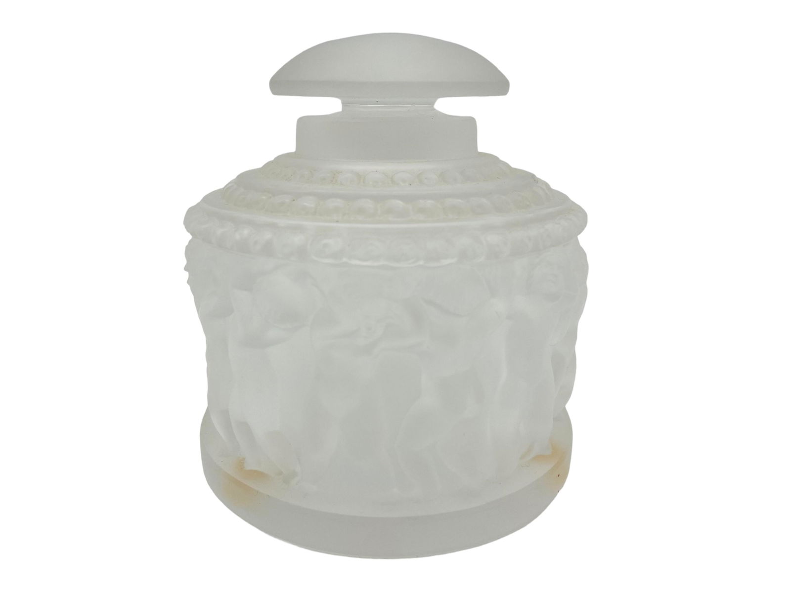 Lalique Frosted Crystal Powder Bottle: Lalique Frosted Crystal Powder Bottle. Frosted glass with cherub motif encircling bottle. Signed on bottom. Measures 4" H x 3 7/8" D. In excellent condition, no chips or cracks. All Items Are Third pa