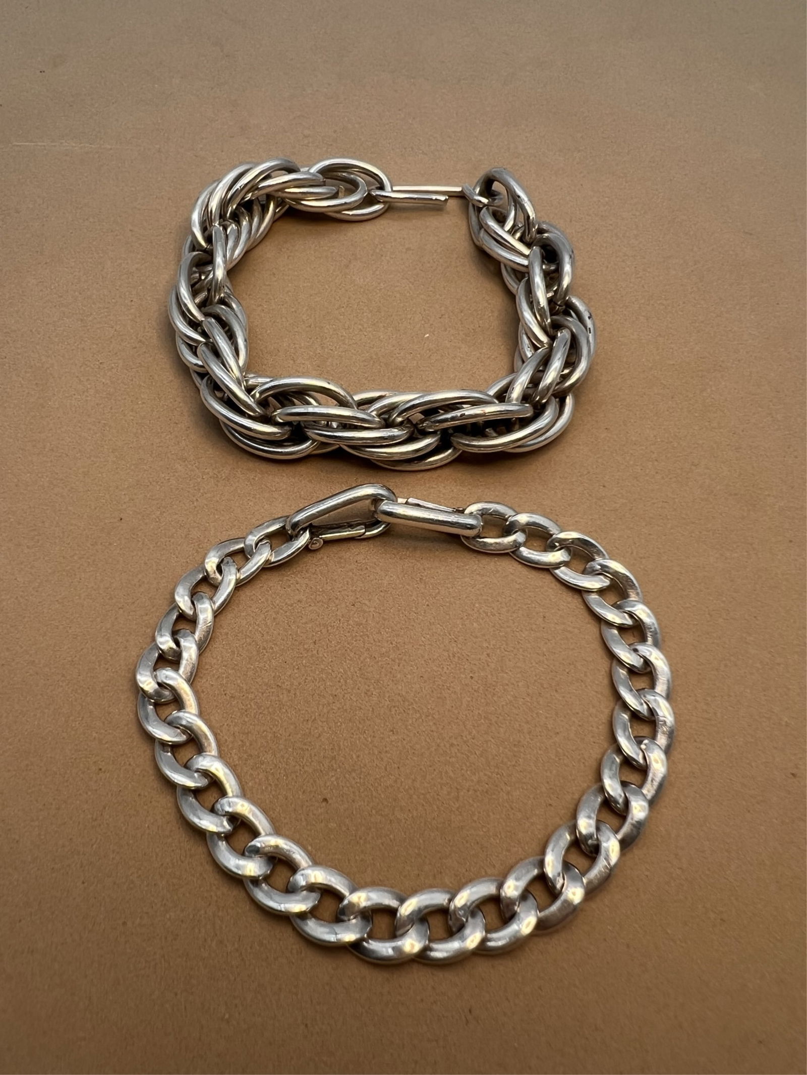 2 Silver Link Bracelets: Classic sterling silver link bracelet. Great starter for a charm bracelet or simply on it's own. Hinged clasp closure. Stamped .925. Measures 7-3/4" L and weighs approx. 18.09 grams. Also a heavy mult