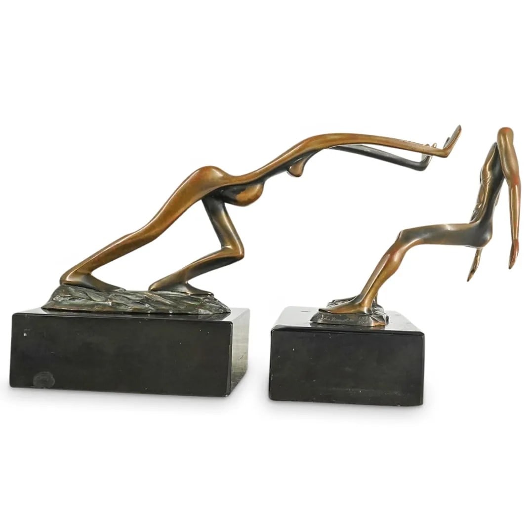 Tom & Bob Bennett Bronze Surrealist Sculptures: Tom & Bob Bennett (20th C) 2 Surrealist Nude Figural Bronze Sculptures/Bookends. Male & female forms on black marble bases. Male signed Tom Bennett '80, 153/500, female signed Bob Bennett '80, 153/500