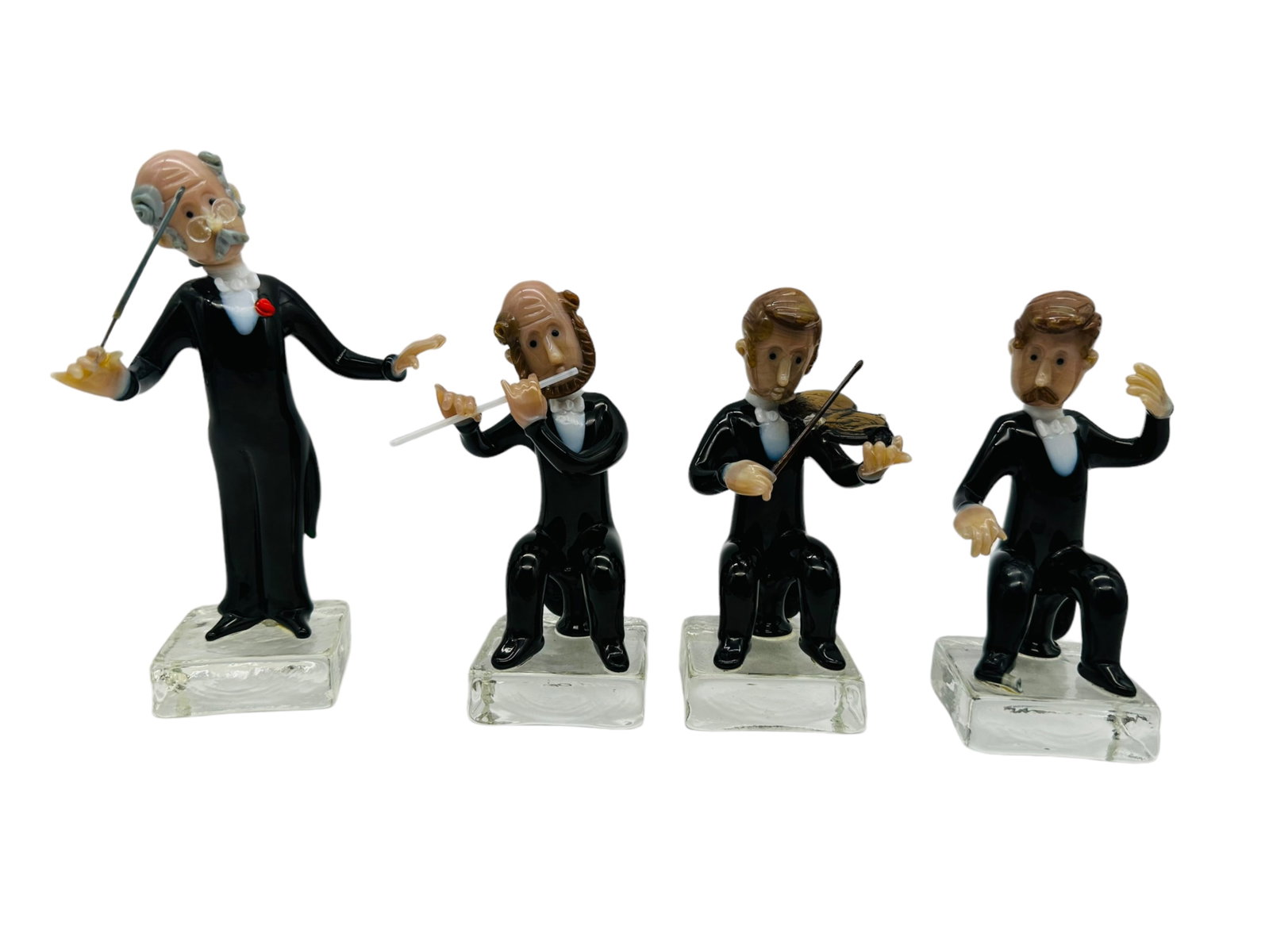 J. Mares Czech Handmade Glass Musicians: Four (4) J. Mares Czech Handmade Glass Musicians. Lot includes: Maestro, Flutist, Violinist, "Celloist, missing cello". Unmarked. Tallest measures 6" H. Third party shipping or free local pick-up with