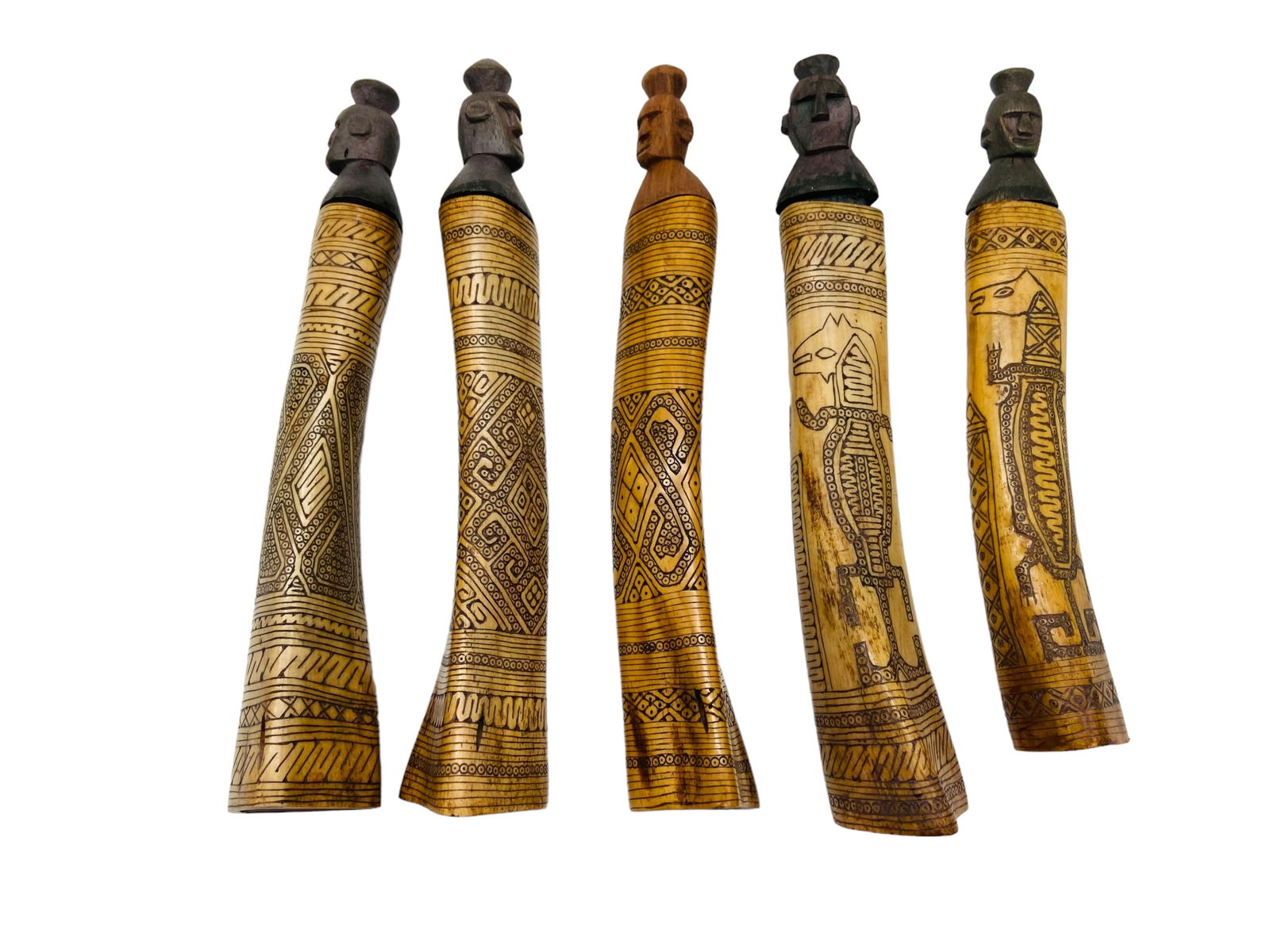 5 Carved Batak Medicine Bone Vessels: 5 Carved Batak Medicine Bone Vessels. Indonesian origin. All bones carved with unique South Pacific patterns, with carved figural heads as stoppers. All measure approximately 9.5" H x 1.5" D. In great