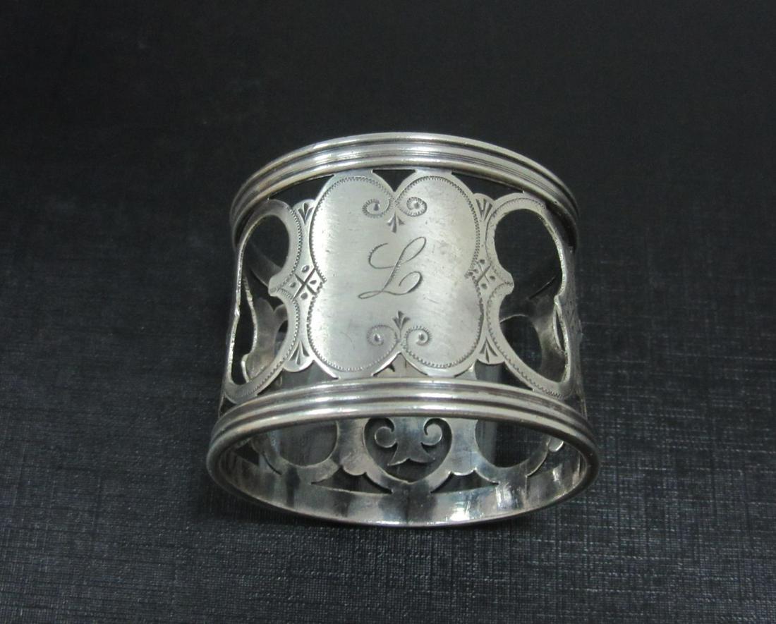 a silver Birmingham silver napkin ring 1909 finely: a silver Birmingham silver napkin ring 1909 finely engraved and inscribed with a L in the cartouche. 26GRAM Hebrew: טבעת מפיות כס•