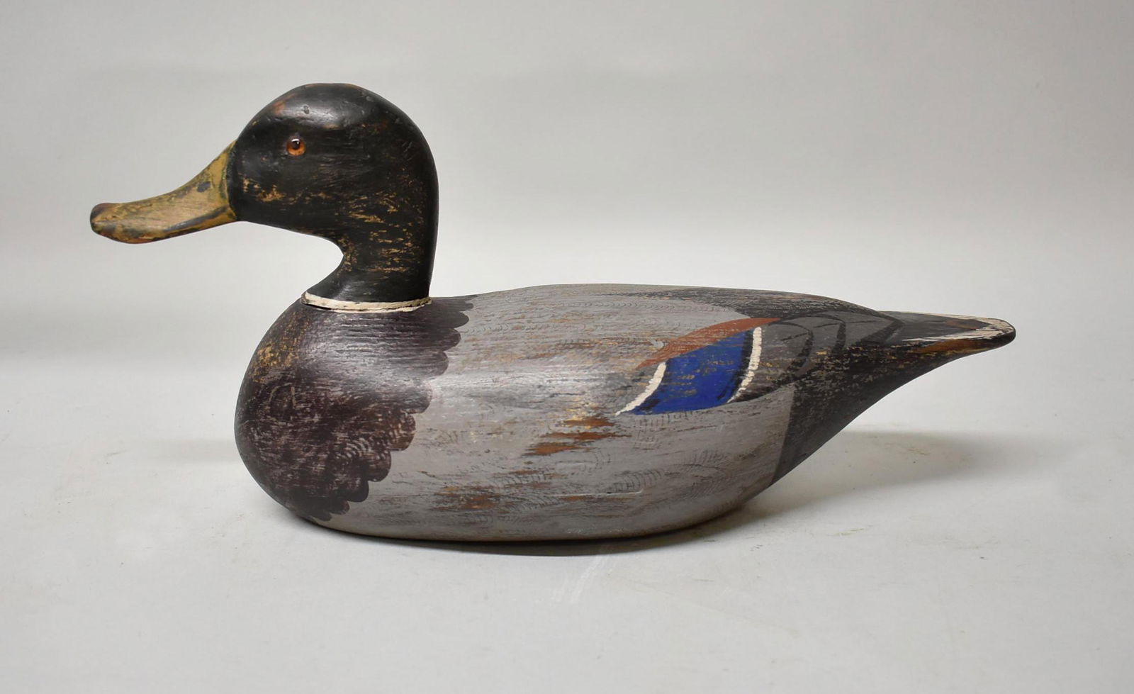 Drake Mallard decoy by Otto Garren/ Charles Moore: Vintage Drake Mallard decoy by Otto Garren repainted by Charles Moore. This model has glass eyes, light paint loss, is hollow, has a detailed bill with carved nostrils. There is a seam at the neck wit