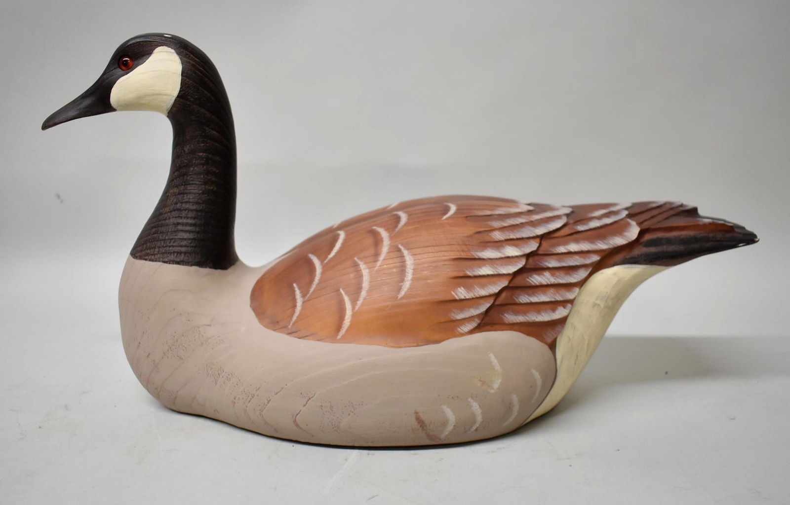 Duck's Unlimited Canadian Goose by Tom Taber: Duck's Unlimited Encore Collection Canadian Goose by Tom Taber. Minor paint chipping on side of tail. Velvet base with medallion on bottom. Dimensions 20" long x 10 3/4" tall x 7 1/4" wide.