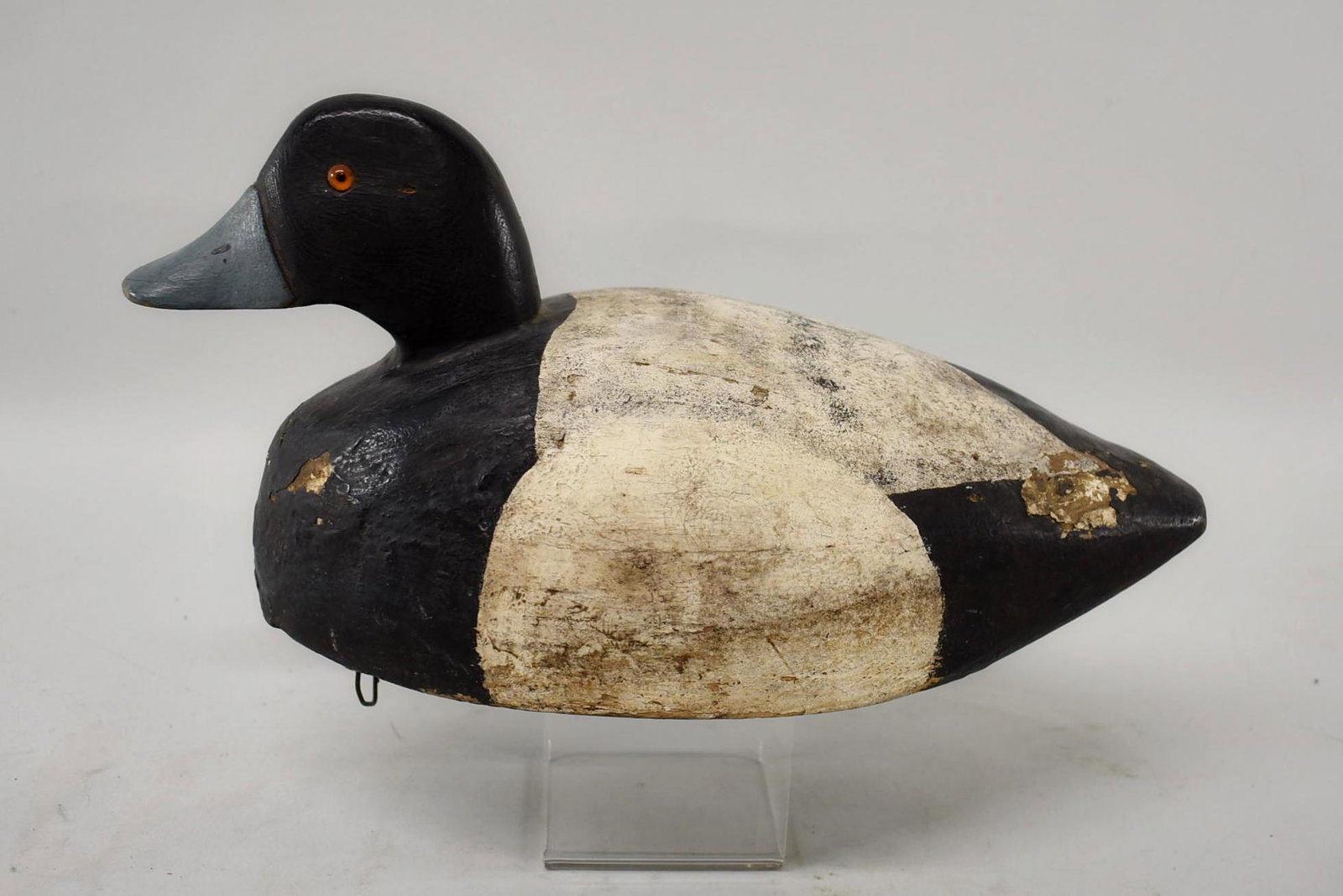 Bluebill Decoy marked M Beck, Parkton, MD: Bluebill duck decoy with paint loss on the front and back. Orange glass eye, wooden keel and weight, gunning model. Dimensions 13 1/2" long x 6 1/2" tall x 6".
