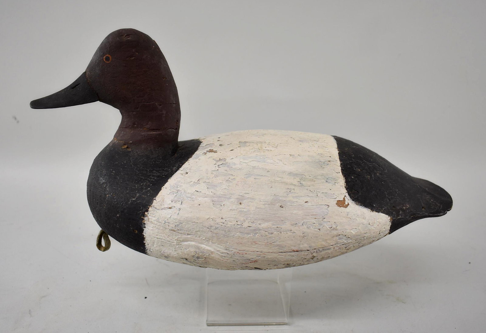Vintage Canvasback Duck Decoy: Vintage Canvasback duck decoy, detailed bill, painted eyes, old repaint, age crack down side, crack at neck, and down back, weight and leather loop on bottom. Dimensions 14 1/2" long x 7" tall x 7" wi
