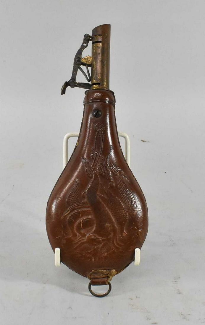 Civil War Era Am Flask Cap Co Leather Powder Flask: Original Civil War Era Leather powder flask with a hunt scene of a rabbit and pheasant. Mechanism works great. Marked Am. Flask and Cap Co on top. Dimensions 8 1/2" tall x 3" wide x 1" deep.
