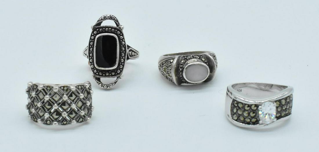 4 Ladies Sterling Rings: 4 Sterling rings. Sterling mother of pearl with marcasite, size 6; Sterling marcasite, clear stone, size 6; Sterling and marcasite diamond pattern, size 6; Sterling and onyx ring, size 7.5, slightly b