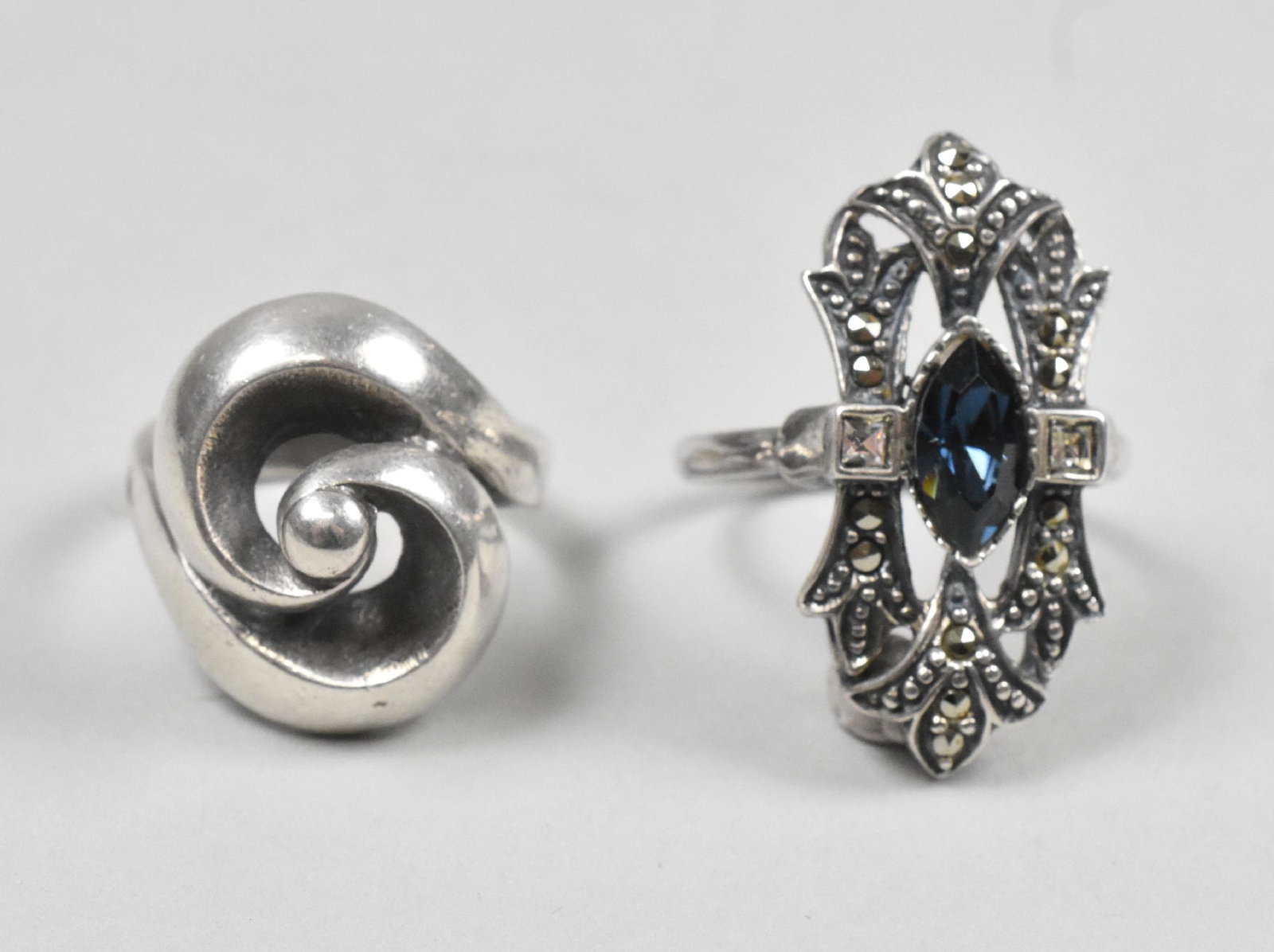 Ottoviani and Giorgio Armani Rings: Ottoviani and Giorgio Armani rings, both marked 925. Ottoviani spiral design size 6 3/4. GA size 10, marcasite and blue stone.