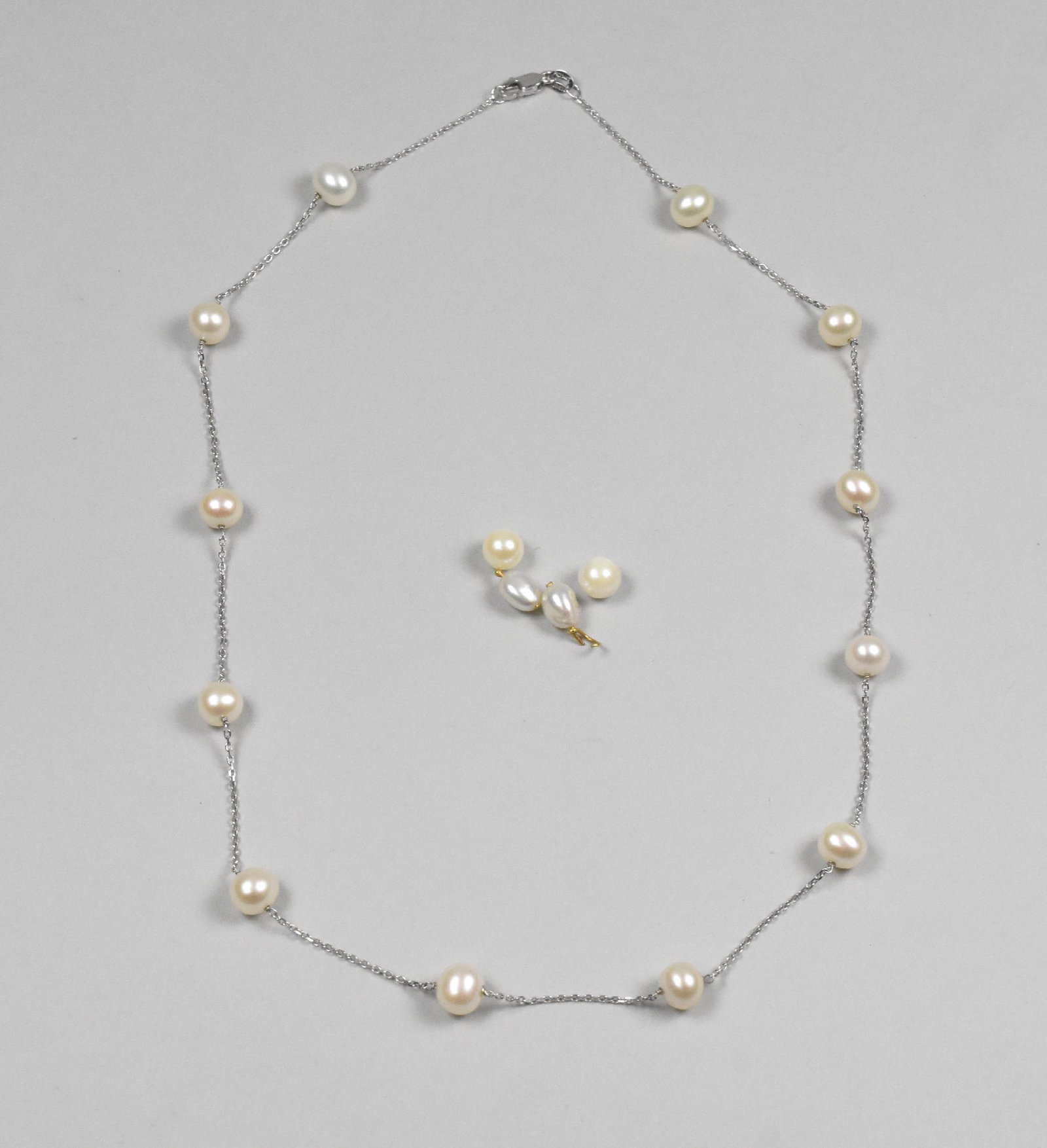 14K Pearl necklace Indonesia: 14K pearl necklace with 12 6mm pearls, 17 1/2" long, marked RCI 14Kt Indonesia. 4 additional loose pearls 6.4mm