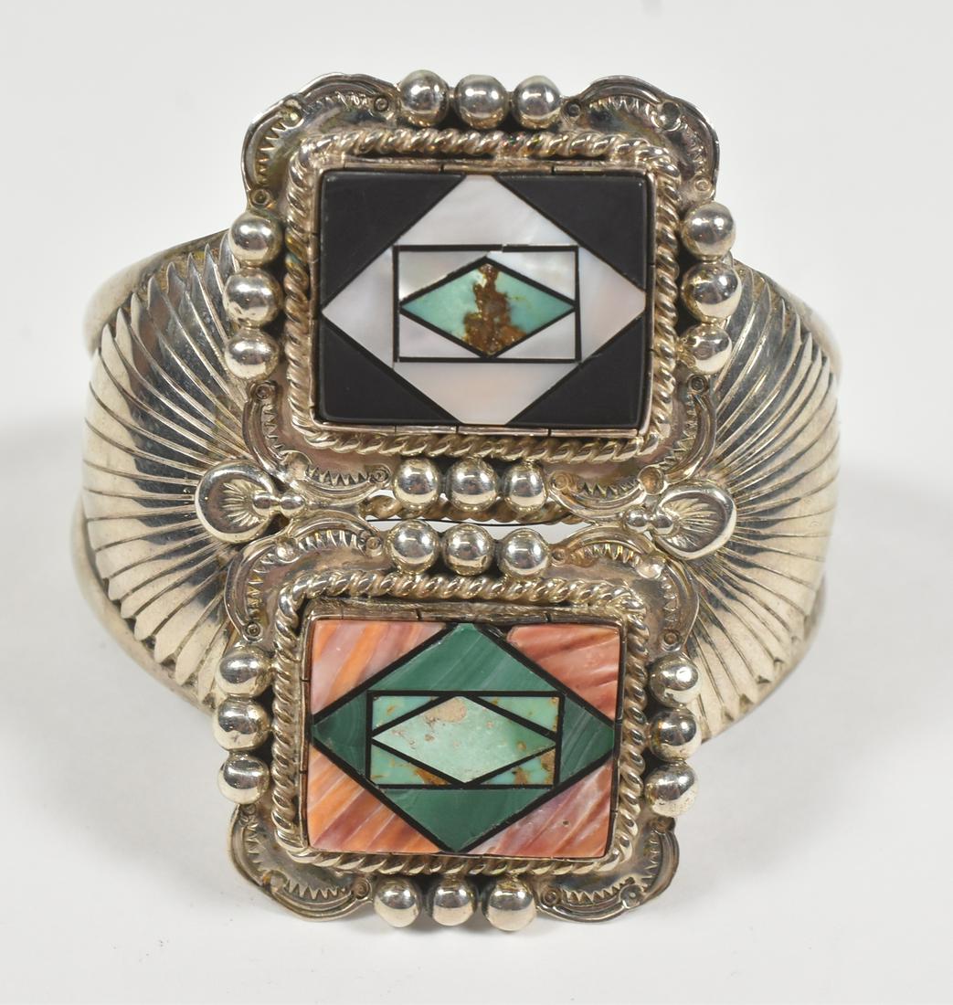 Native American Bracelet Sterling: Native American Bracelet, marked sterling with initials ML, mother of pearl, turquoise, malachite. Front detailing measures 2 1/2" x 1 3/8", 6 1/4" long. 76.7 grams.