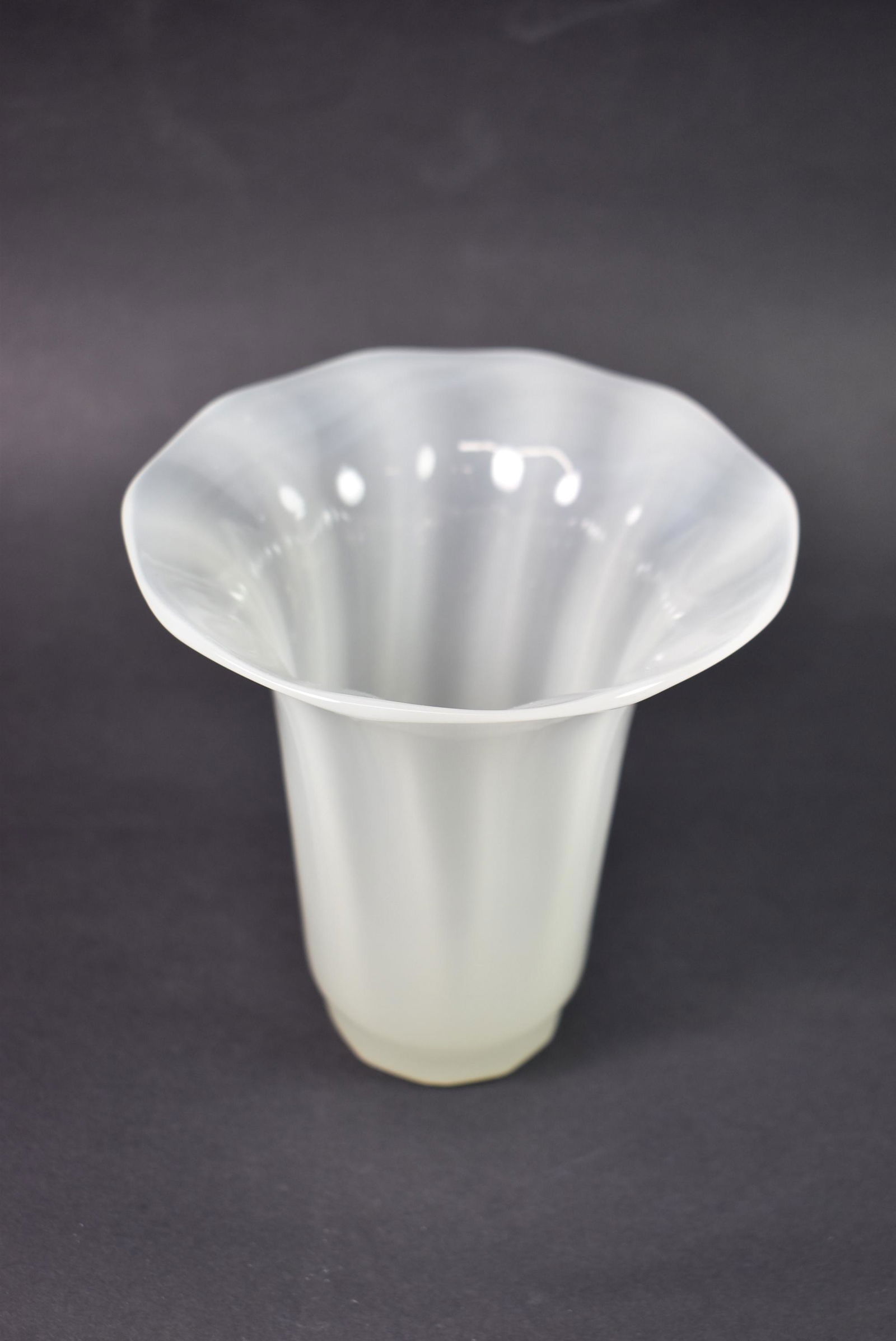 Steuben Vase with Flared Rim: Steuben vase with flared rim. Made to look like a shade with a ribbed design. 5 3/8" x 5 1/4" diameter. Base is 2 1/8" diameter. Not signed, some bubbles in manufacturing.