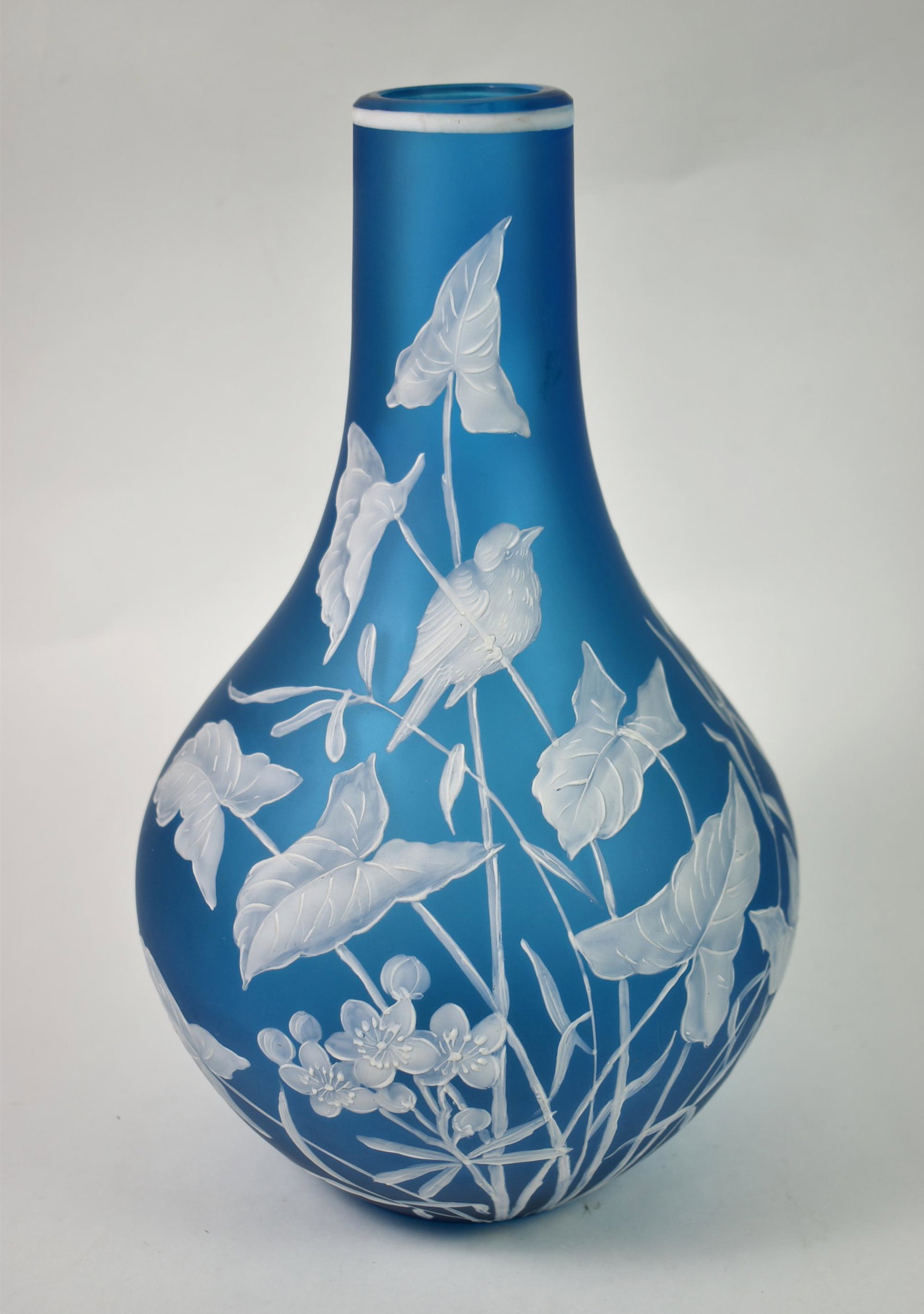 Blue Satin Glass Vase by Webb 11" tall: Blue satin glass vase decorated by Webb. Enameled hand painted work of birds and foliage. 11" tall x 6 1/2" diameter. Slight imperfection or chip on rim.