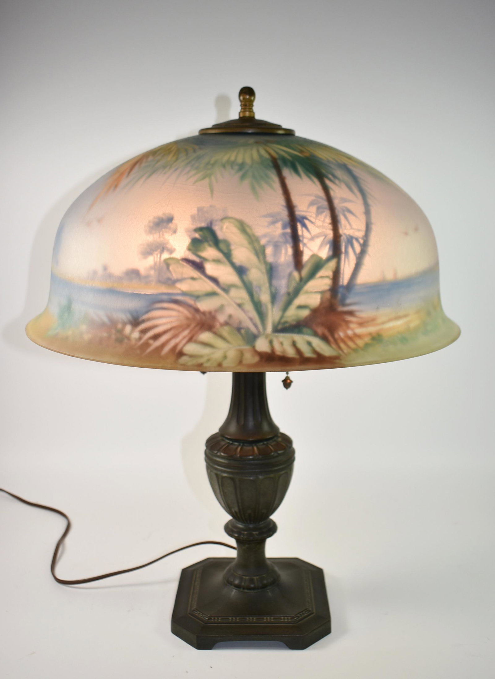 Antique Pairpoint Reverse Painted Lamp Palm Trees Tropical Scene Signed: Shade signed with a tropical scene. A stunning Pairpoint reverse painted table lamp. The shade depicts a tropical scene with a beach and palm trees. The shade is signed. Very good condition with no da