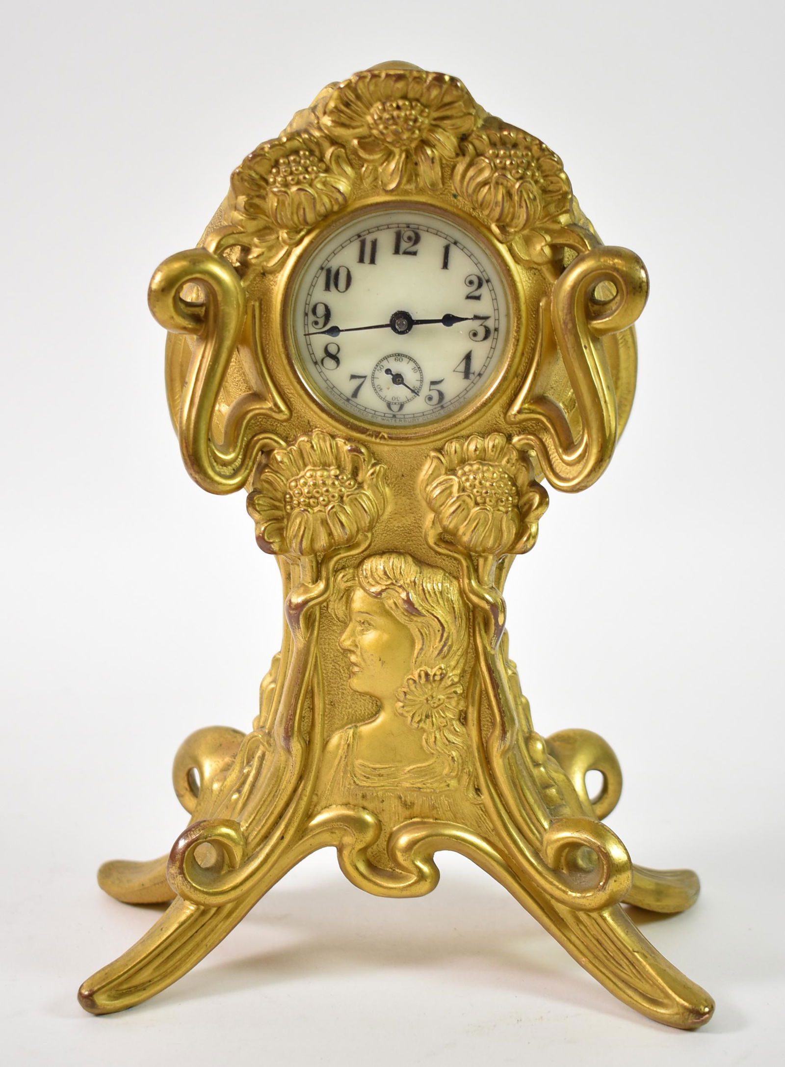 French Style Waterbury Clock, Art Nouveau: French style Waterbury Clock Co, USA. Art Nouveau, Art Deco, gold dore French style figural ladies. Portrait center with flowers. 8 1/4" tall x 6 1/4 x 2 1/4". Clock not run tested.