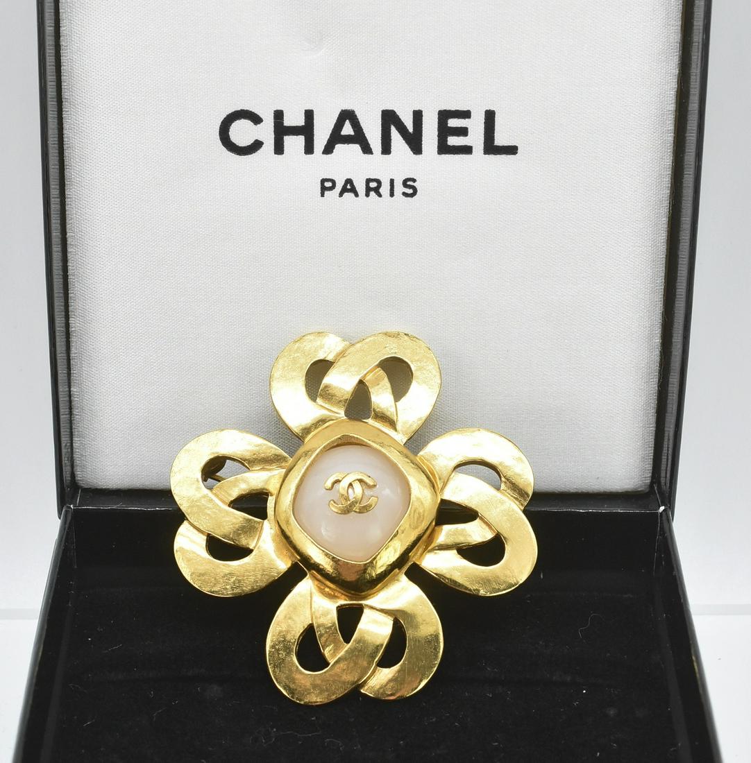 Chanel Spring 1997 Gold Tone and Pearl Brooch: Chanel Spring 1997 gold tone and pearl brooch. 2" x 2 1/4". 4 leaf clover design, Stamped 97P. Original box. 28.4 grams