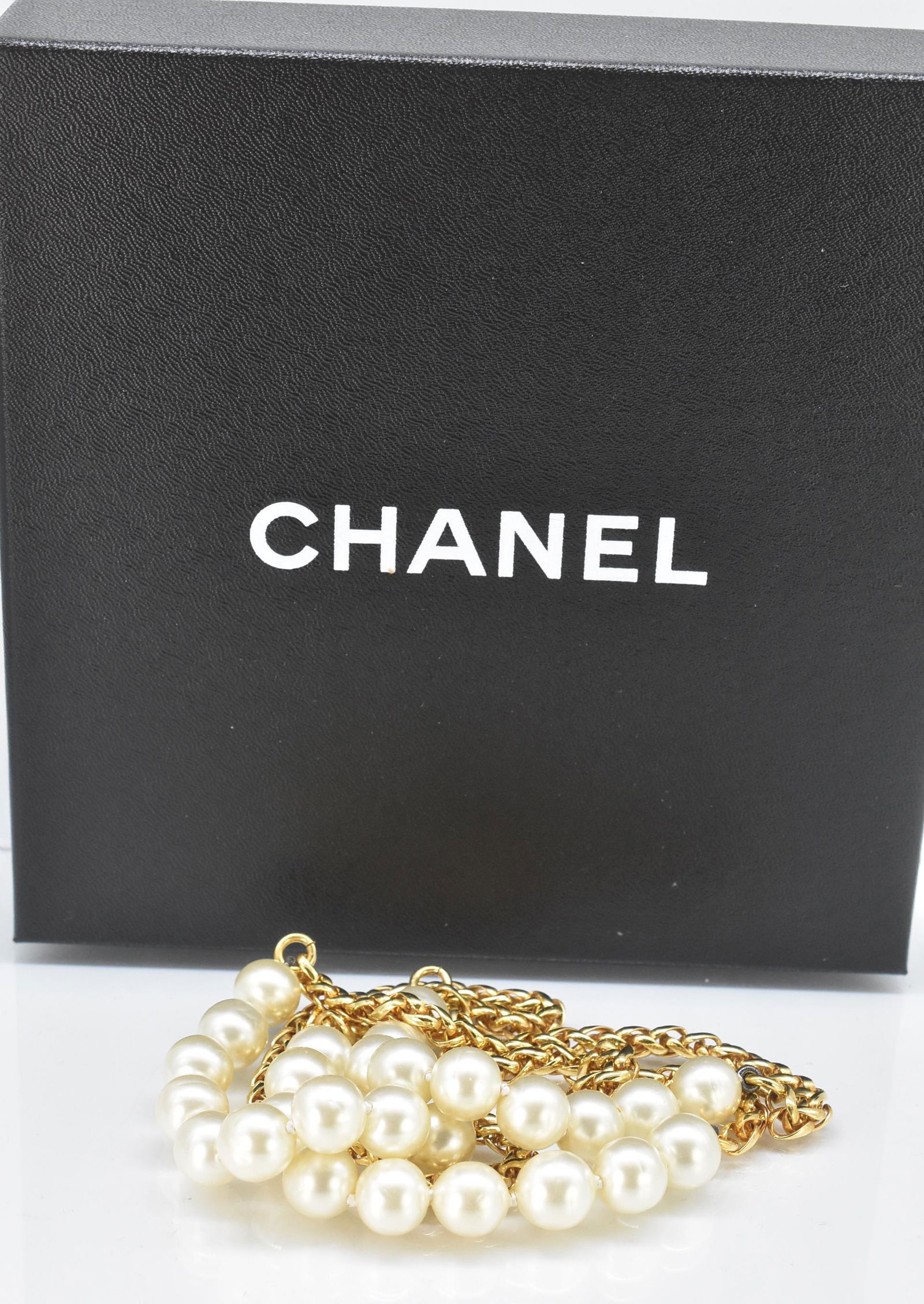 Chanel Gold Tone and Faux Pearl Necklace: Chanel gold tone and faux pearl necklace. Round chain link with pearls. 32" long. Stamped. Original Box, old tape on it. 108 grams