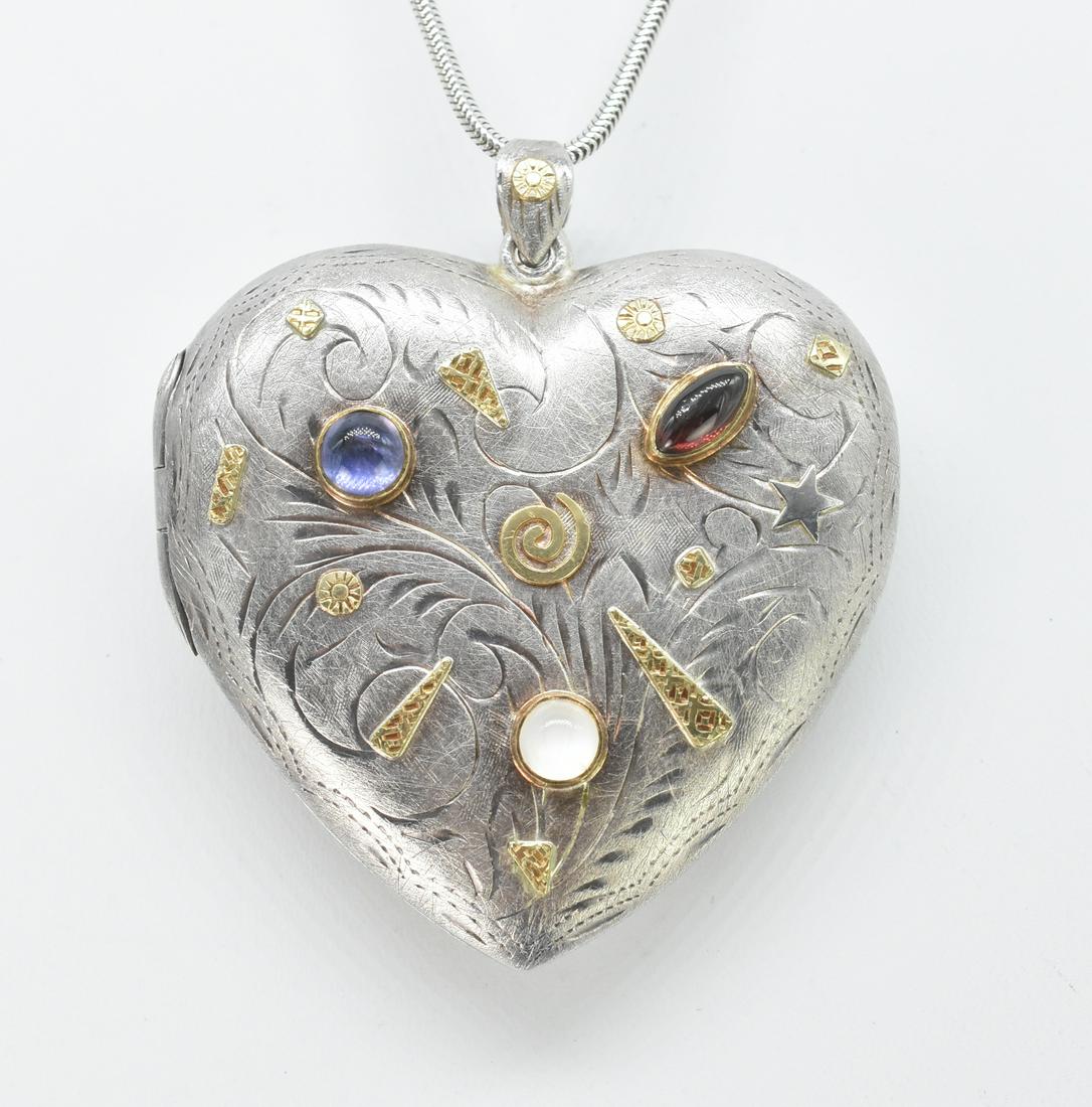 925 and 22K Locket with Semi Precious Stones: Sterling silver 925 locket with 22K gold detailing with semi precious stones. Signed Eduardo Rubio-Arzate '95. Locket measures 22" wide x 2 1/4" including bail. 29" chain also signed by artist. 36.2 g