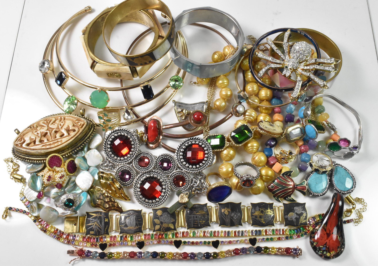 Costume Jewelry, Elephant, Fish, Spider: Variety of Costume Jewelry. Damascene Japan Bracelet marked K24. Bone carved bracelet Made in India. 9 Bracelets. 3.25" Bone carved elephant pendant. 3 Pendants, small green cross with a broken clasp.