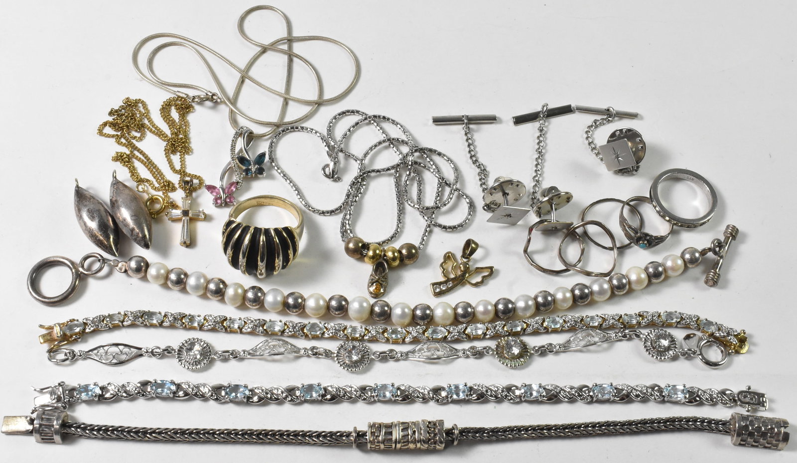Sterling Jewelry Lot, Tie Tacks, Bracelets, Necklaces: This group of sterling jewelry has a variety of necklaces, bracelets and rings. There are 5 bracelets, 7 1/2". A pair of football shaped enhancer drops for earrings are in this lot along with three ti