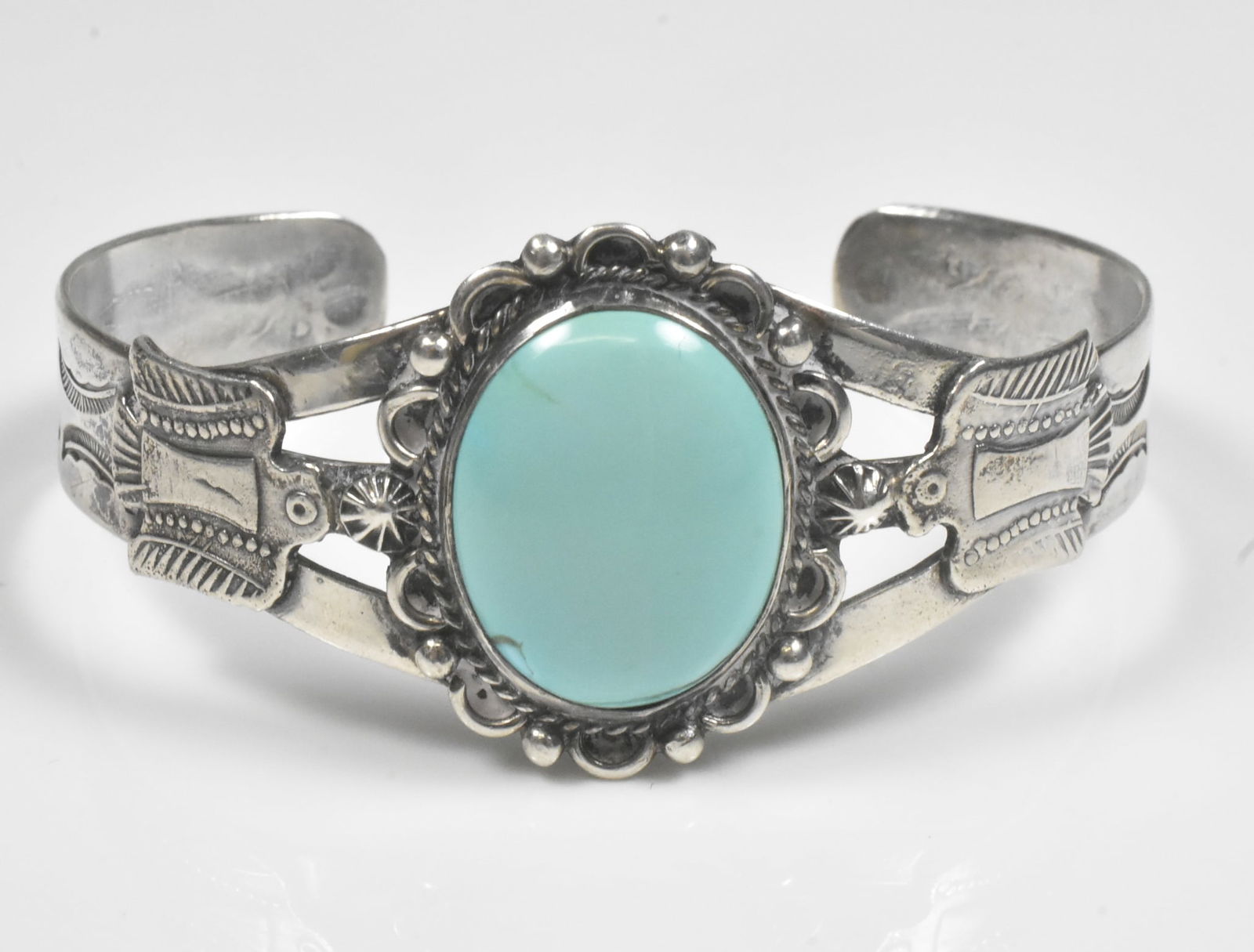 Sterling and Turquoise Cuff Bracelet: Cuff bracelet in sterling with turquoise center stone. Not marked. 5 1/4" with 1" gap. 21.5g.