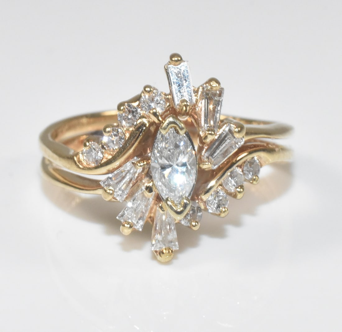 14k Yellow Gold and Diamond Engagement and Wedding Ring Set: 14k yellow gold wedding set with center marquis cut diamond with 6 baguettes and 8 round diamonds, .75ctw. Size 6. Rings are soldered together but could be separated by a jeweler. 3.9g.