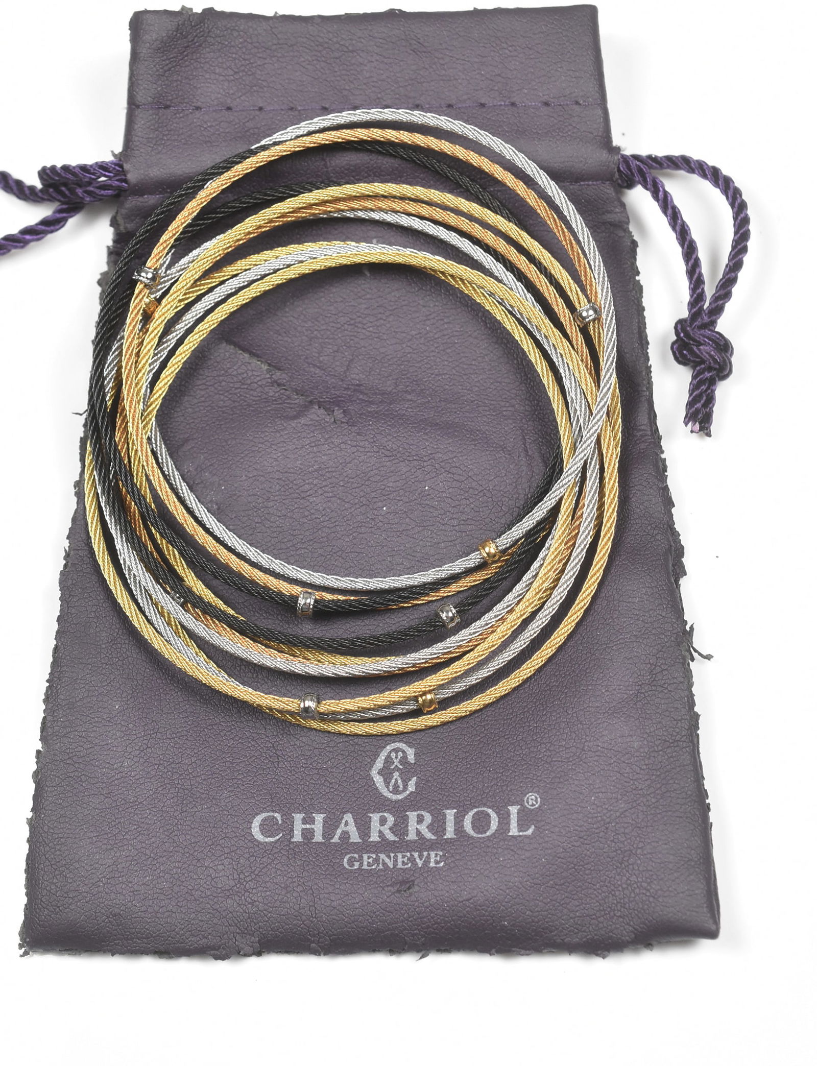 10 Strand Charriol Bracelet: Charriol bracelet with 10 intertwined bangles in silver tone, gold tone, copper tone and black. 7 3/4".