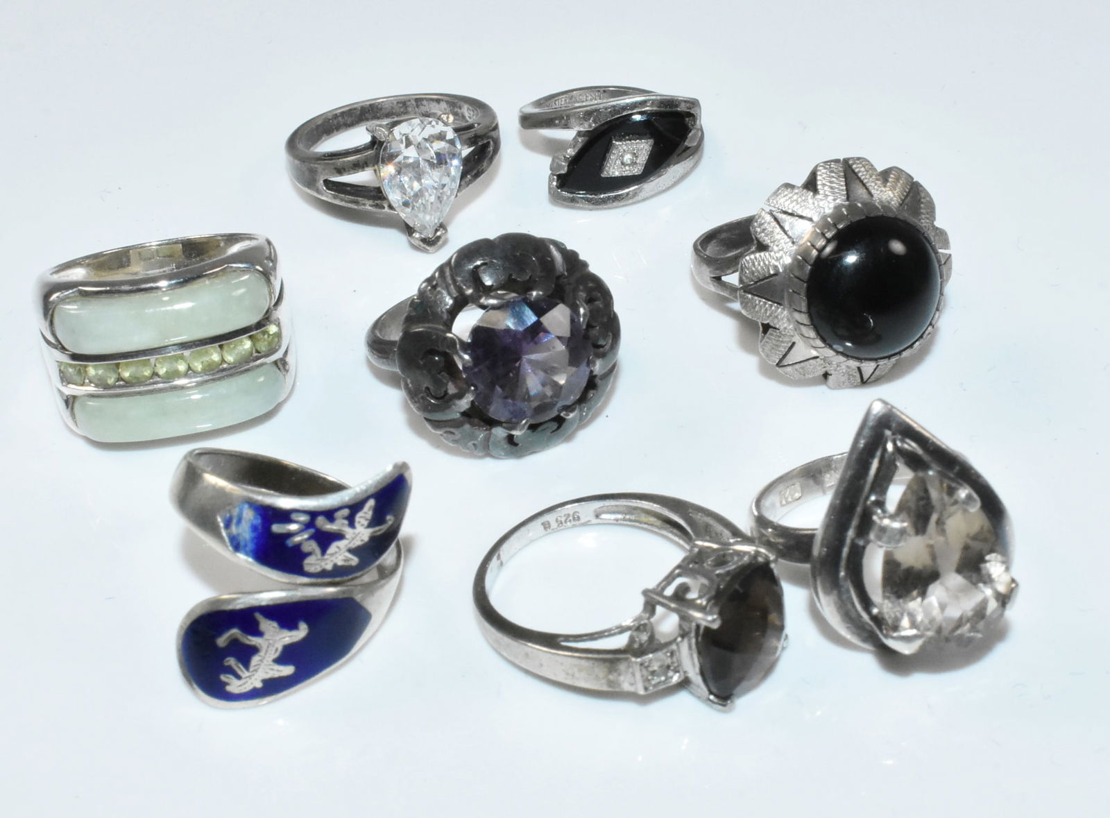 Sterling Rings Group: Group of 9 sterling rings sizes 3-8. Star ring has chip on the enamel. 50.3g