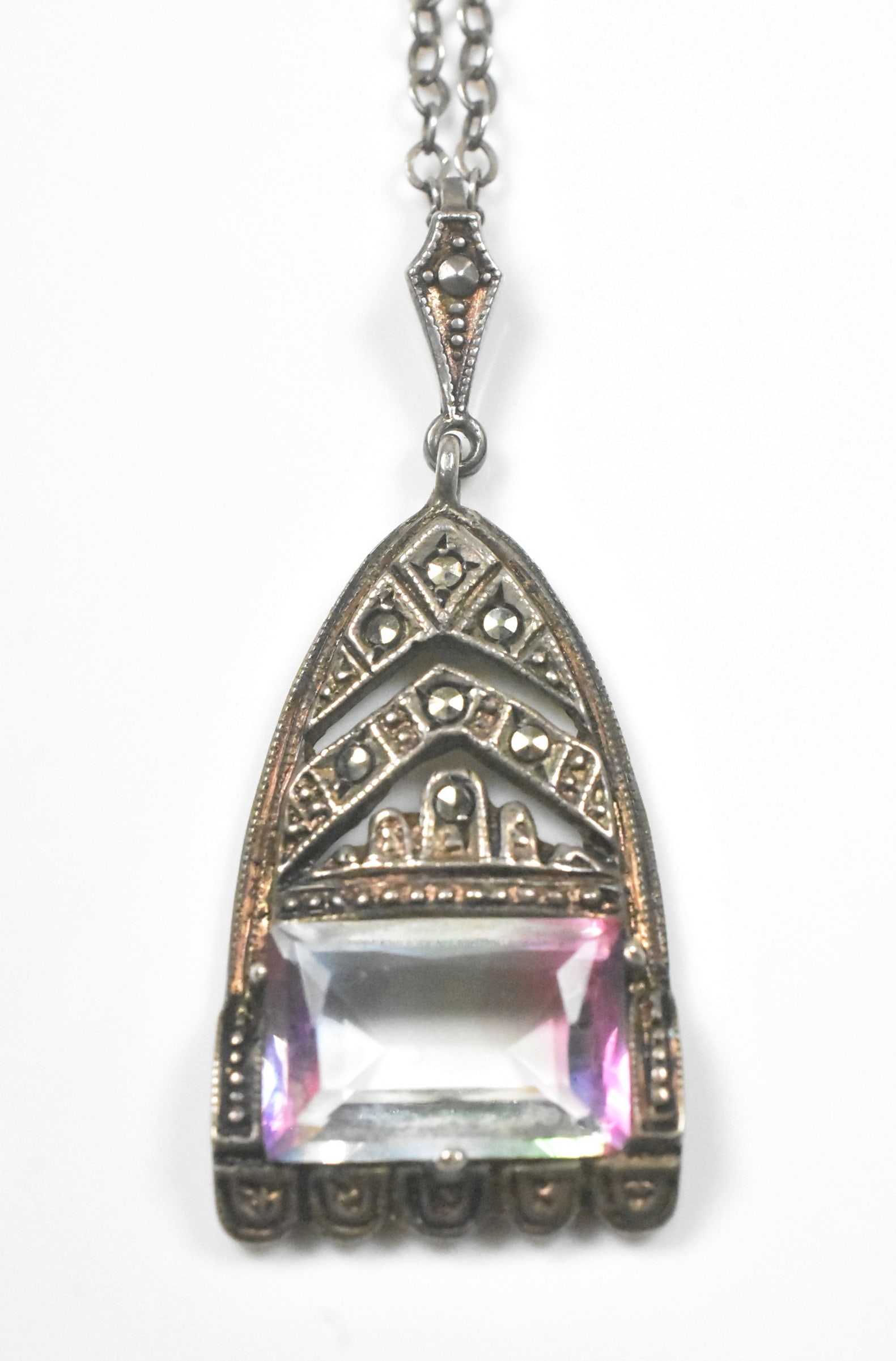 Vintage 830 Silver and Marcasite Pendant Necklace: Vintage necklace in 830 silver. Unique pendant with marcasite and an emerald cut stone clear in the middle and purple on the edges. 1 1/4" long, 17" chain with flower clasp. 5.4g.