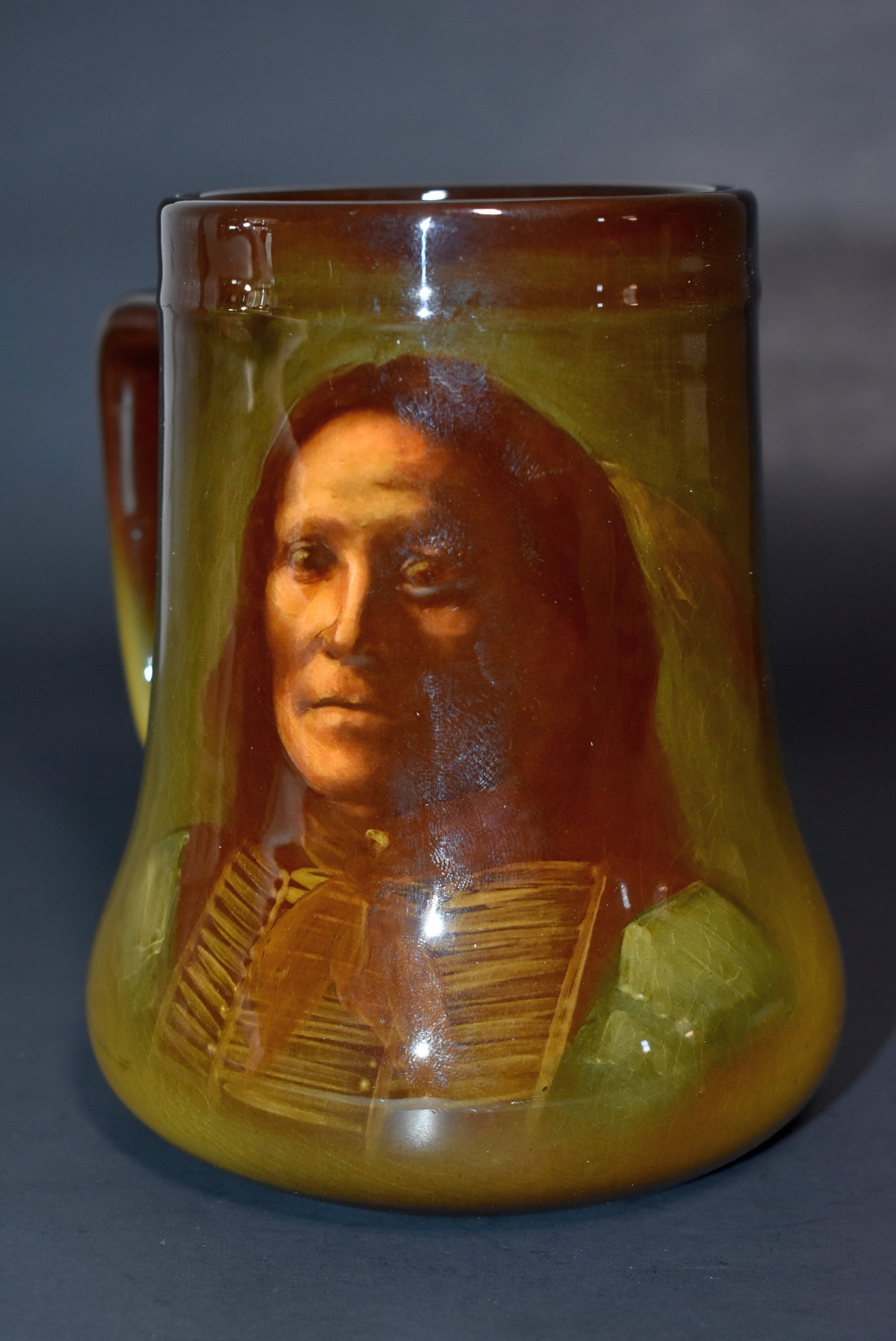Rookwood Sioux Indian Chief Mug #656 1900 Edith R. Felton: Rookwood standard glaze mug #656, 1900 with Sioux Indian chief, inscribed Chief Goes to War. Artist signed ERF for Edith R. Felton. 5" tall.