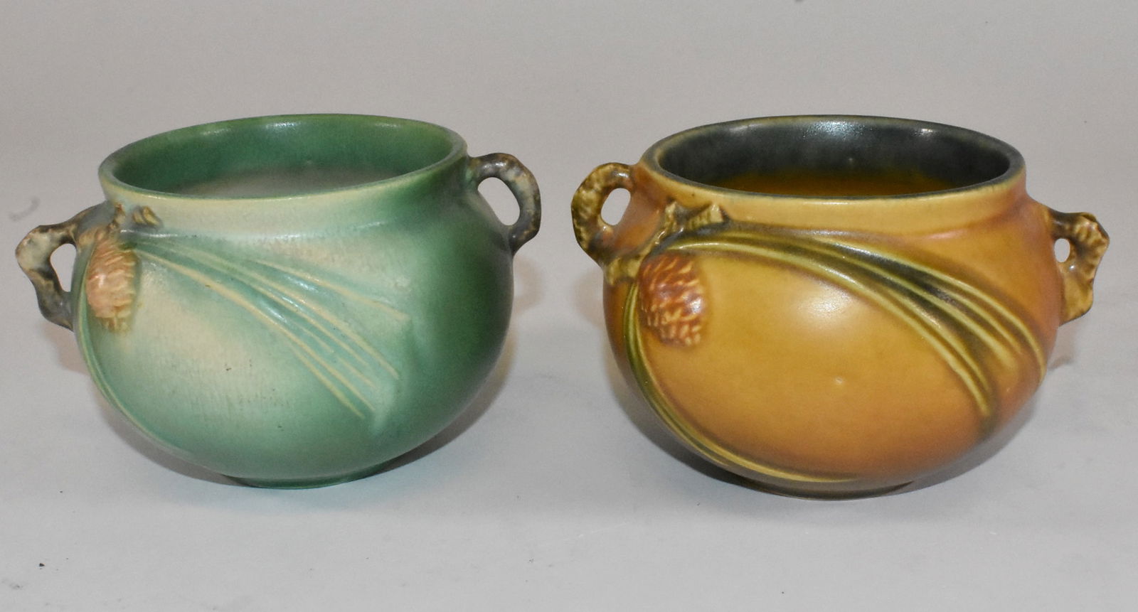 2 Roseville Pinecone Vases: Roseville pinecone vases, 1 brown, 1 green. 3" tall x 5 1/4" wide. Excellent condition.