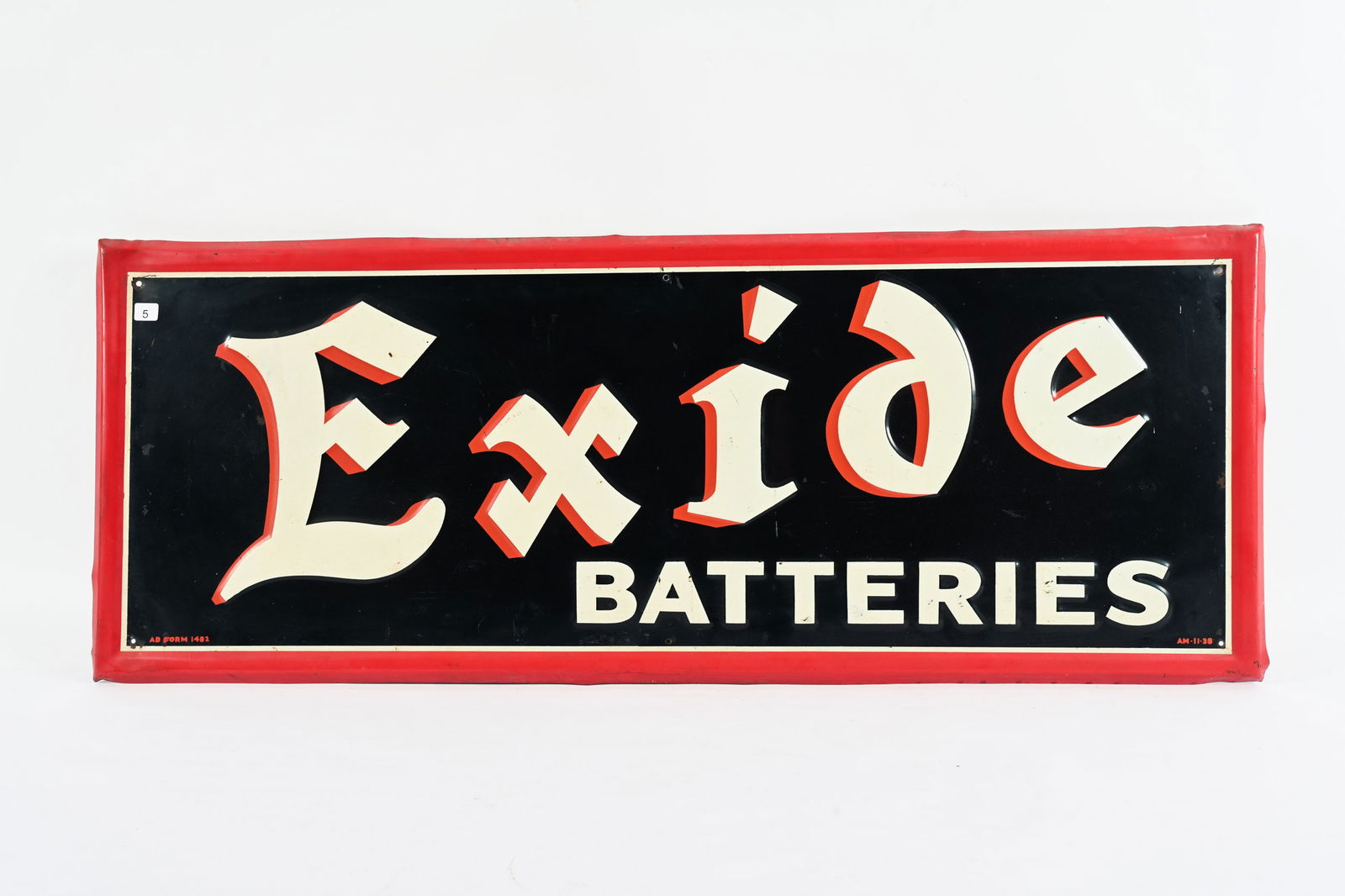 1938 EXIDE BATTERIES EMBOSSED TIN SIGN: 1938 EXIDE BATTERIES EMBOSSED TIN SIGN MARKED AM-11-38 AD FORM 1482 SELF FRAMED EDGE STRONG COLOURS AND GLOSS FIELD IN GOOD CONDITION WITH MINOR SURFACE SCRATCHES SOME EDGE WEAR WITH PAINT LOSS PRESEN