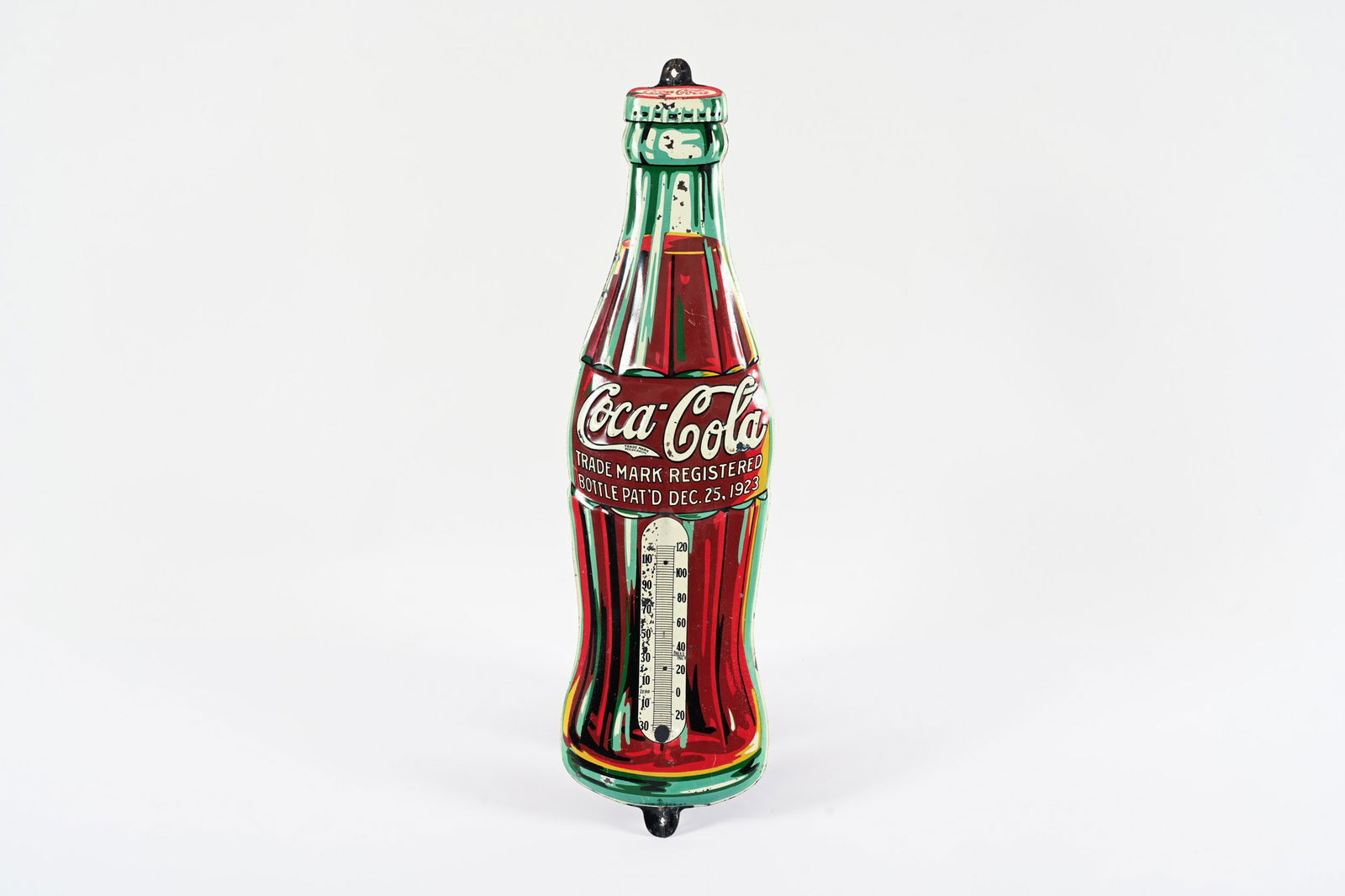 1933 COCA-COLA CHRISTMAS BOTTLE TIN THERMOMETER: 1933 COCA-COLA "CHRISTMAS BOTTLE" EMBOSSED TIN THERMOMETER MARKED MADE IN USA 33 GOOD COLOURS AND GLOSS FIELD SHOWS SOME AREAS OF SCATTERED WEAR WITH PAINT LOSS MISSING TUBE 5"X17" *ALL ITEMS GUARANTE