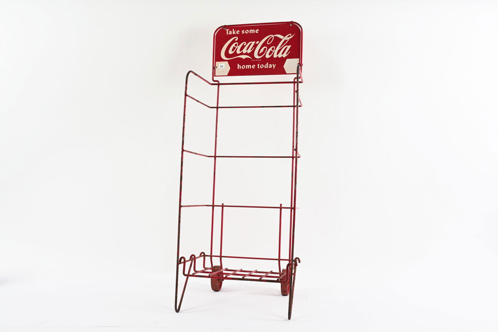 COCA-COLA WIRE ROLLING BOTTLE RACK: COCA-COLA TAKE SOME HOME TODAY WIRE ROLLING BOTTLE RACK NOT MARKED DOUBLE SIDED PAINTED METAL RACK SIGN IN GOOD CONDITION SHOWS SOME PAINT LOSS ON BACK SIDE OF RACK SIGN 17"X14"X43" *ALL ITEMS GUARANT