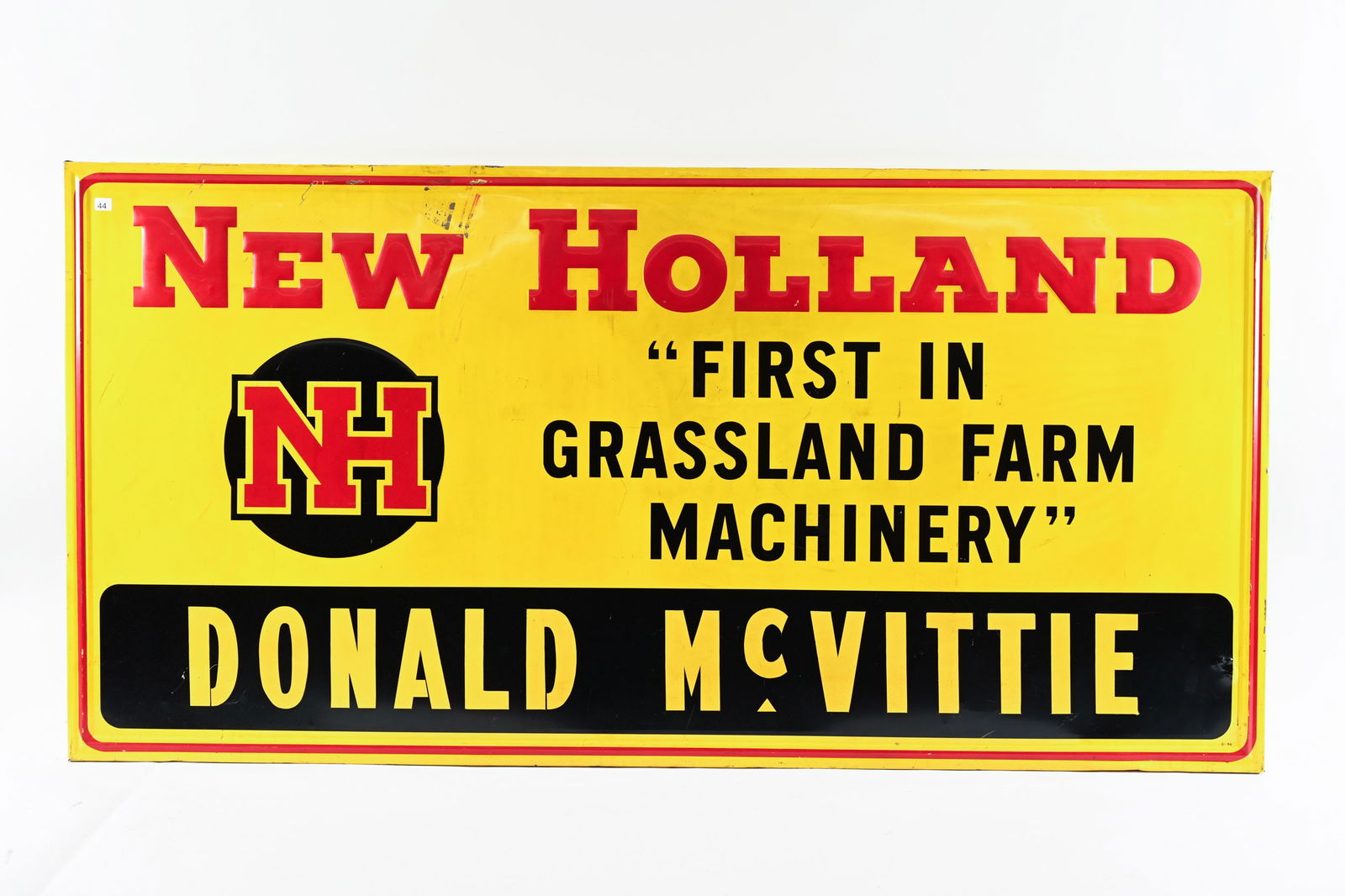NEW HOLLAND DONALD MCVITTIE DEALER SIGN: NEW HOLLAND DONALD MCVITTIE EMBOSSED TIN DEALER SIGN MARKED G-44 ON FRONT SIDE BACK SIDE MARKED GRACE SIGN CO. ST. LOUIS DONALD MCVITTIE ALLISTON, ONTARIO SELF FRAMED WITH ORIGINAL WOODEN BACKING 