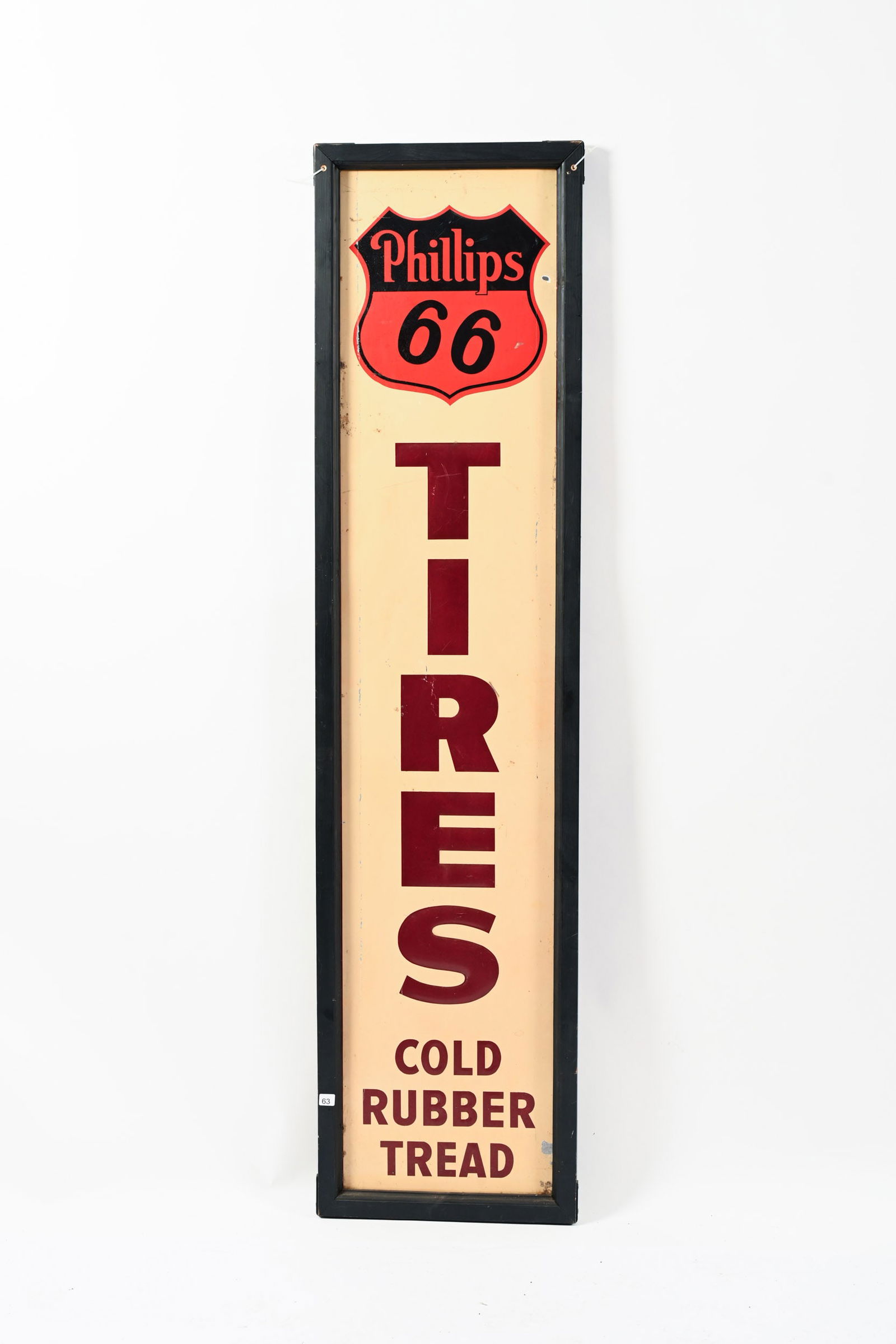 PHILLIPS 66 TIRES EMBOSSSED TIN VERTICAL SIGN: PHILLIPS 66 TIRES COLD RUBBER THREAD EMBOSSED TIN VERTICAL SIGN MAKERS MARK COVERED BY ADDED WOODEN FRAME GOOD COLOURS AND GLOSS SHOWS SOME WEAR, OXIDATION AND PAINT LOSS IN FIELD LINE OF PAINT