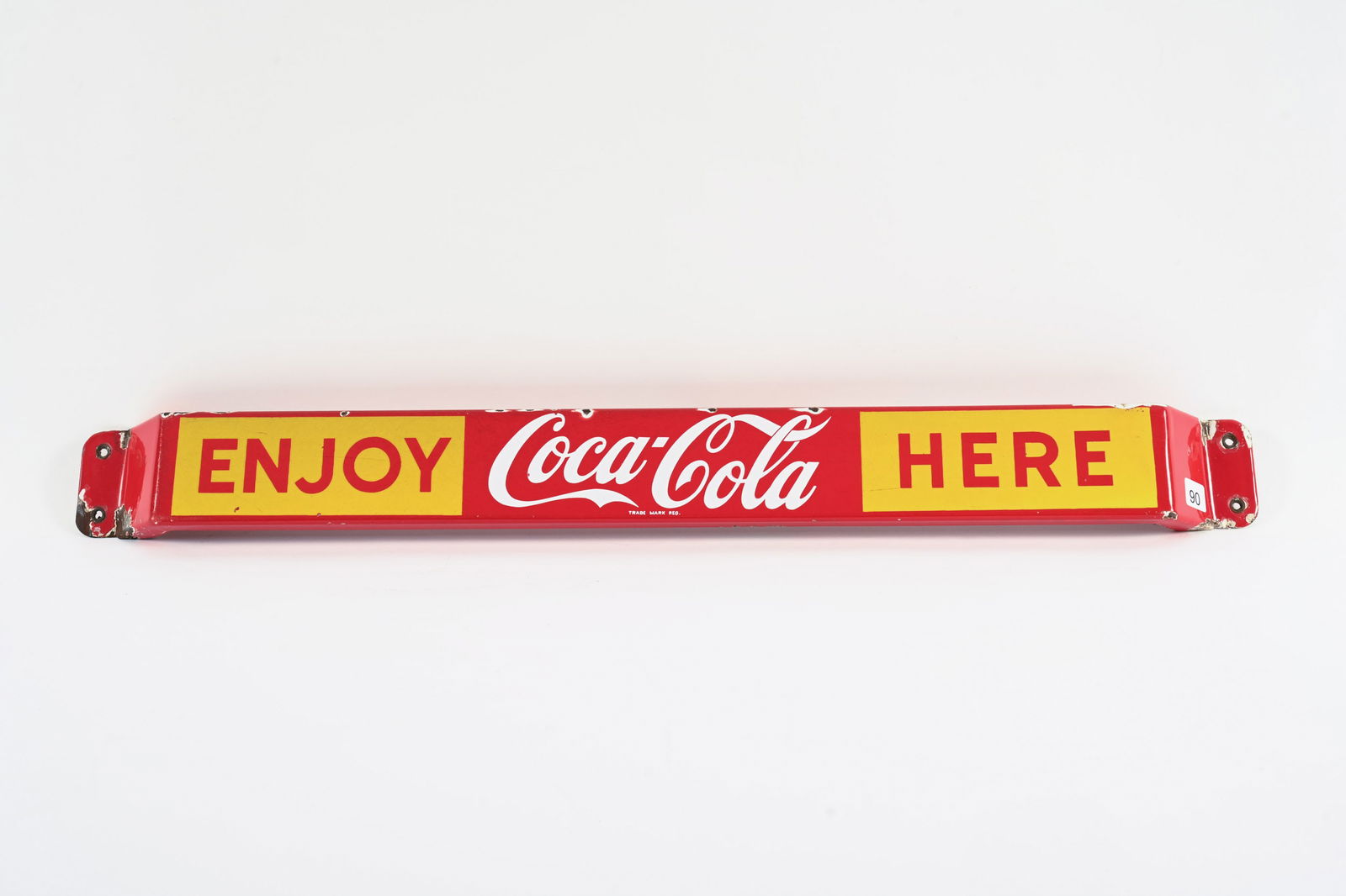 ENJOY COCA-COLA HERE PORCELAIN PUSH BAR: ENJOY COCA-COLA HERE PORCELAIN PUSH BAR MARKED MADE IN CANADA CM 60-006 GOOD COLOURS AND GLOSS SURFACE SCRATCHES IN FIELD PORCELAIN LOSS AT TOP EDGE AND MOUNTING ENDS WHITE PAINT TOUCH UP TO