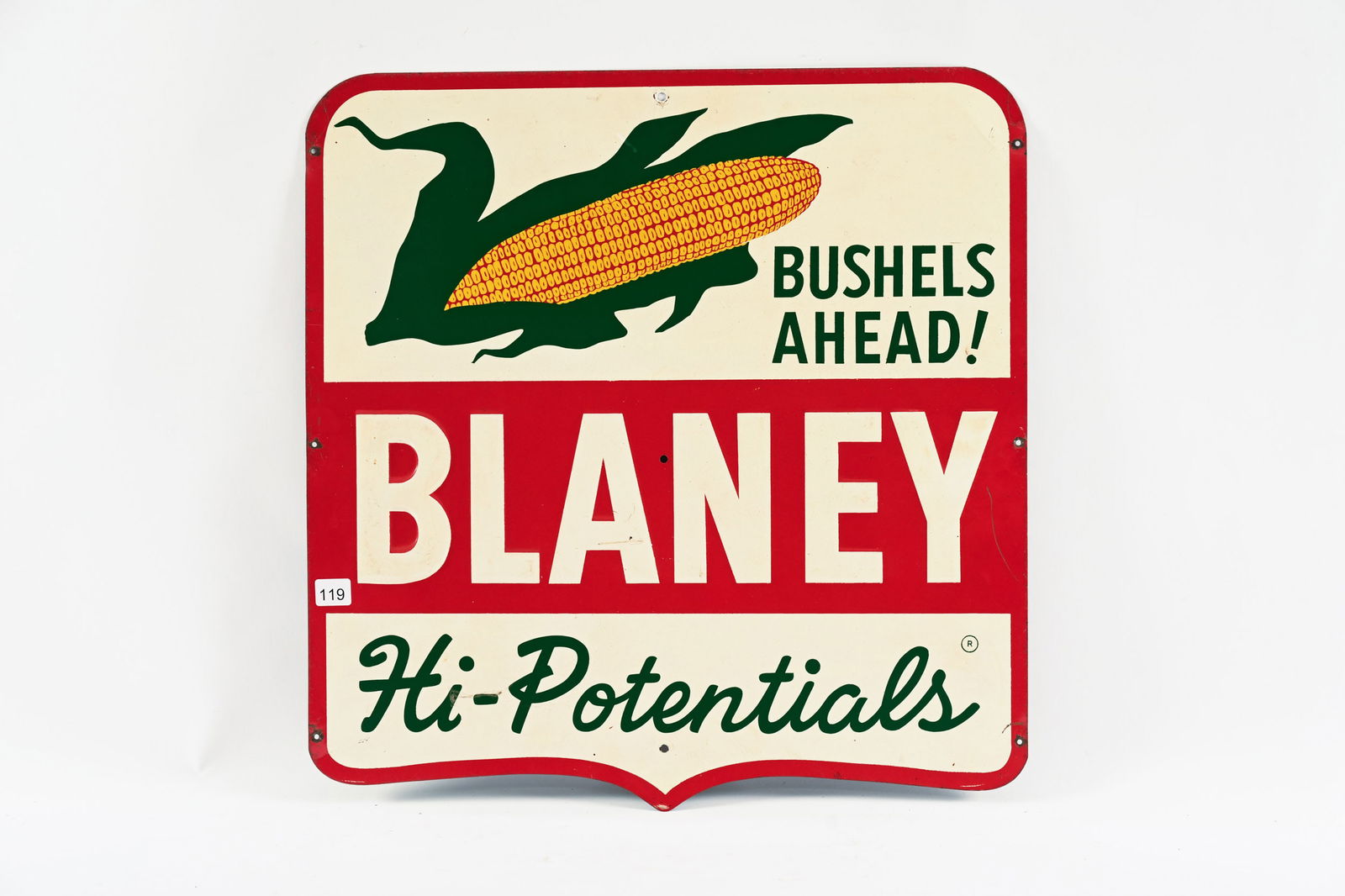 BLANEY HI-POTENTIALS EMBOSSED TIN SIGN: BLANEY HI-POTENTIALS "BUSHELS AHEAD!" EMBOSSED TIN SIGN NOT MARKED GOOD COLOURS AND GLOSS FIELD IN GOOD CONDITION WITH MINOR SURFACE SCRATCHES WITH PAINT LOSS EXTRA HOLES ADDED AROUND PERIMETER 20"X20