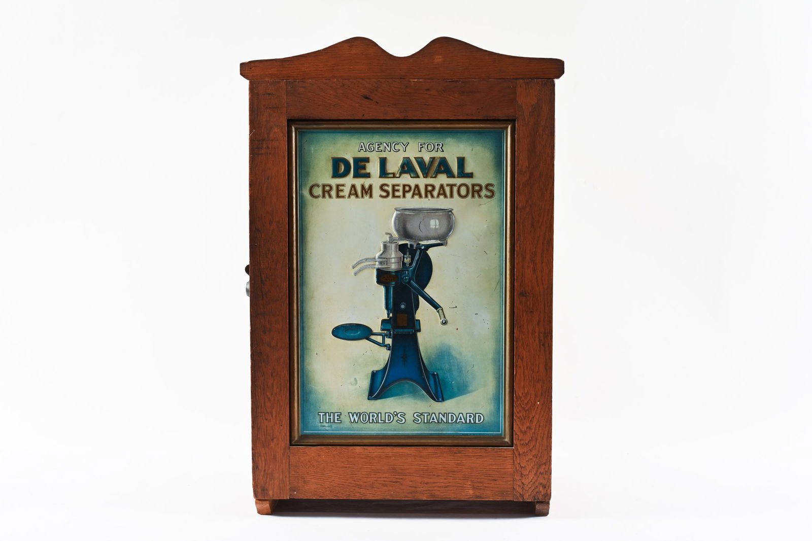 DE LAVAL CREAM SEPARATORS CABINET: DE LAVAL CREAM SEPARATORS "THE WORLD'S STANDARD" CABINET OAK CABINET WITH EMBOSSED TIN SIGN FRONT SIGN SHOWS SOME WEAR, SURFACE SCRATCHES AND FADING 19"X11"X28"