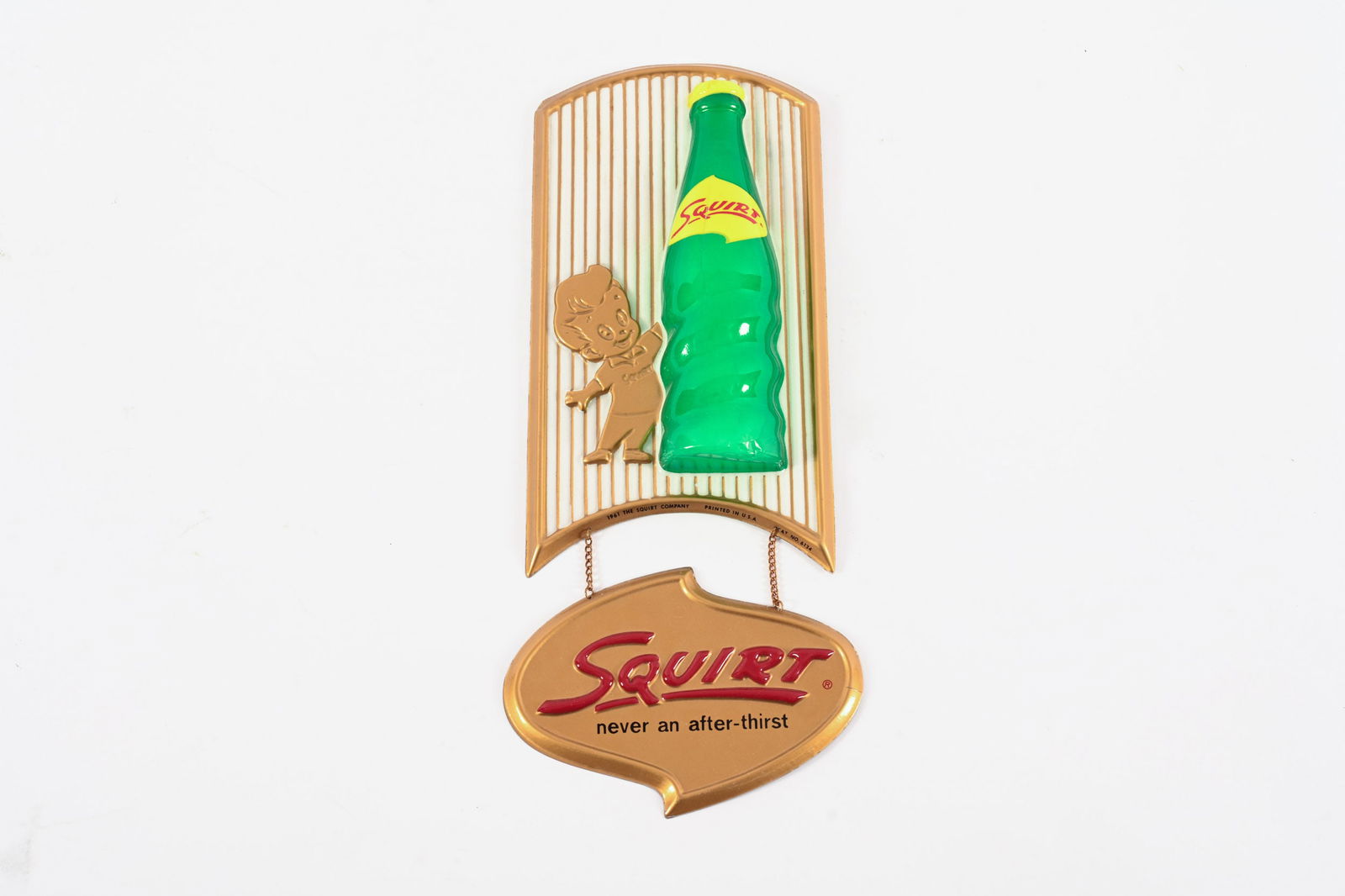 1961 SQUIRT VACUFORMED PLASTIC SIGN: 1961 SQUIRT "NEVER AN AFTER-THIRST" VACUFORMED PLASTIC SIGN MARKED THE SQUIRT COMPANY PRINTED IN U.S.A GOOD CONDITION SLIGHT CREASE TO BOTTLE CAP MINOR CRACK TO RIGHT EDGE OF LOWER HANGING SIGN 