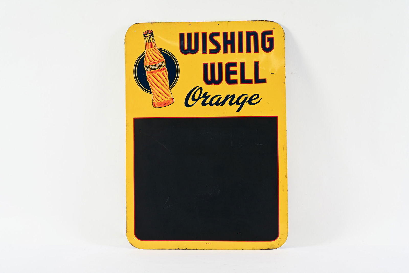 WISHING WELL ORANGE EMBOSSED TIN CHALKBOARD SIGN: WISHING WELL ORANGE EMBOSSED TIN CHALKBOARD SIGN MARKED S.T.S.P (ST. THOMAS STEEL PRODUCTS) NEW OLD STOCK CONDITION SHOWS SOME WEAR AND OXIDATION TO UPPER EDGE MINOR PAINT LOSS TO THE RIGHT OF THE