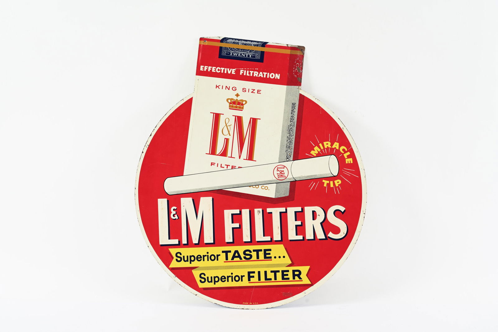 L&M MIRACLE TIP FILTERS EMBOSSED TIN SIGN: L&M MIRACLE TIP FILTERS EMBOSSED TIN SIGN MARKED MADE IN U.S.A. GOOD COLOURS AND GLOSS SHOWS SOME AREAS OF SURFACE WEAR AND PAINT LOSS PAINT LOSS MOST EVIDENT AT TOP RIGHT EDGE 25"X29" *ALL ITEMS GUAR