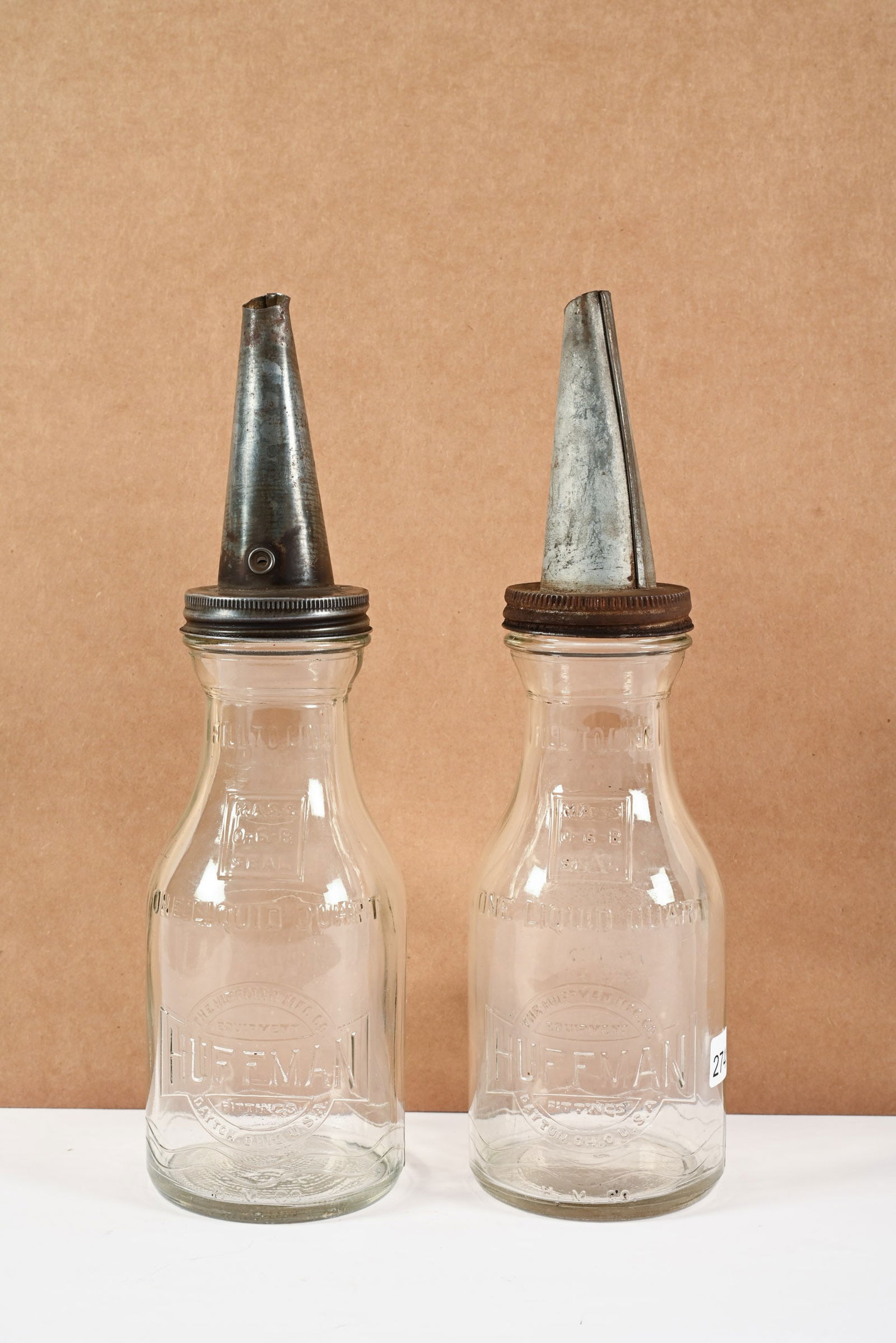 PAIR OF HUFFMAN GLASS QT MOTOR OIL BOTTLES W/SPOUTS: PAIR OF HUFFMAN GLASS QUART MOTOR OIL BOTTLES WITH SPOUTS HUFFMAN MFG, CO. DAYTON, OHIO EMBOSSED GLASS NO CHIPS OR CRACKS