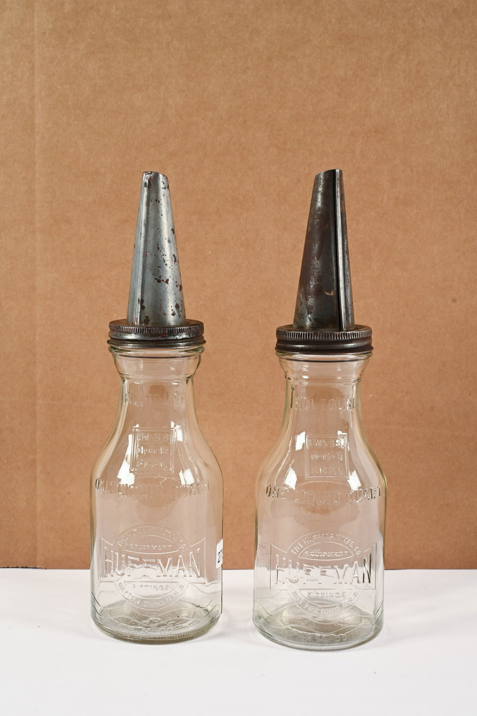 PAIR OF HUFFMAN GLASS QT MOTOR OIL BOTTLES W/SPOUTS: PAIR OF HUFFMAN GLASS QUART MOTOR OIL BOTTLES WITH SPOUTS HUFFMAN MFG, CO. DAYTON, OHIO EMBOSSED GLASS NO CHIPS OR CRACKS