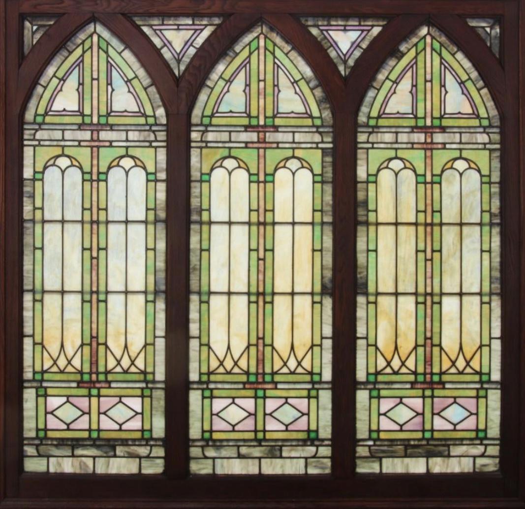 Antique 3 part stained glass in original oak frame: This 3 part Gothic arch window is in great shape.There are 4 kite panels between Gothic arch. Lighting has been added to back side of frame, but can be removed. No cracks or damage, very good conditio