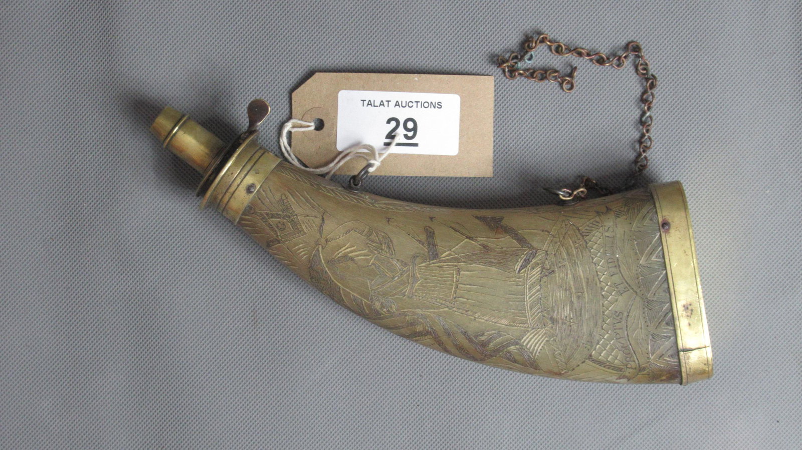 Fine Carved Powder Horn with Masonic motifs: Brass mounted curved horn finely carved with Masonic motifs & Latin inscription. Also carved with a woman bearing the 'Stars & Stripes' and a three masted sailing ship. Length 24cm.