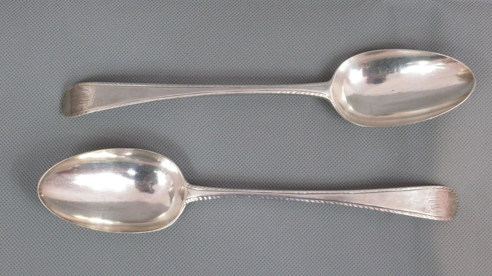 Georgian Silver Pair Hester Bateman Table Spoons: With Clear Georgian Hallmarks, London 1782. Measuring 21.5cm. Chased edges. Initialled. Weight 127g.
