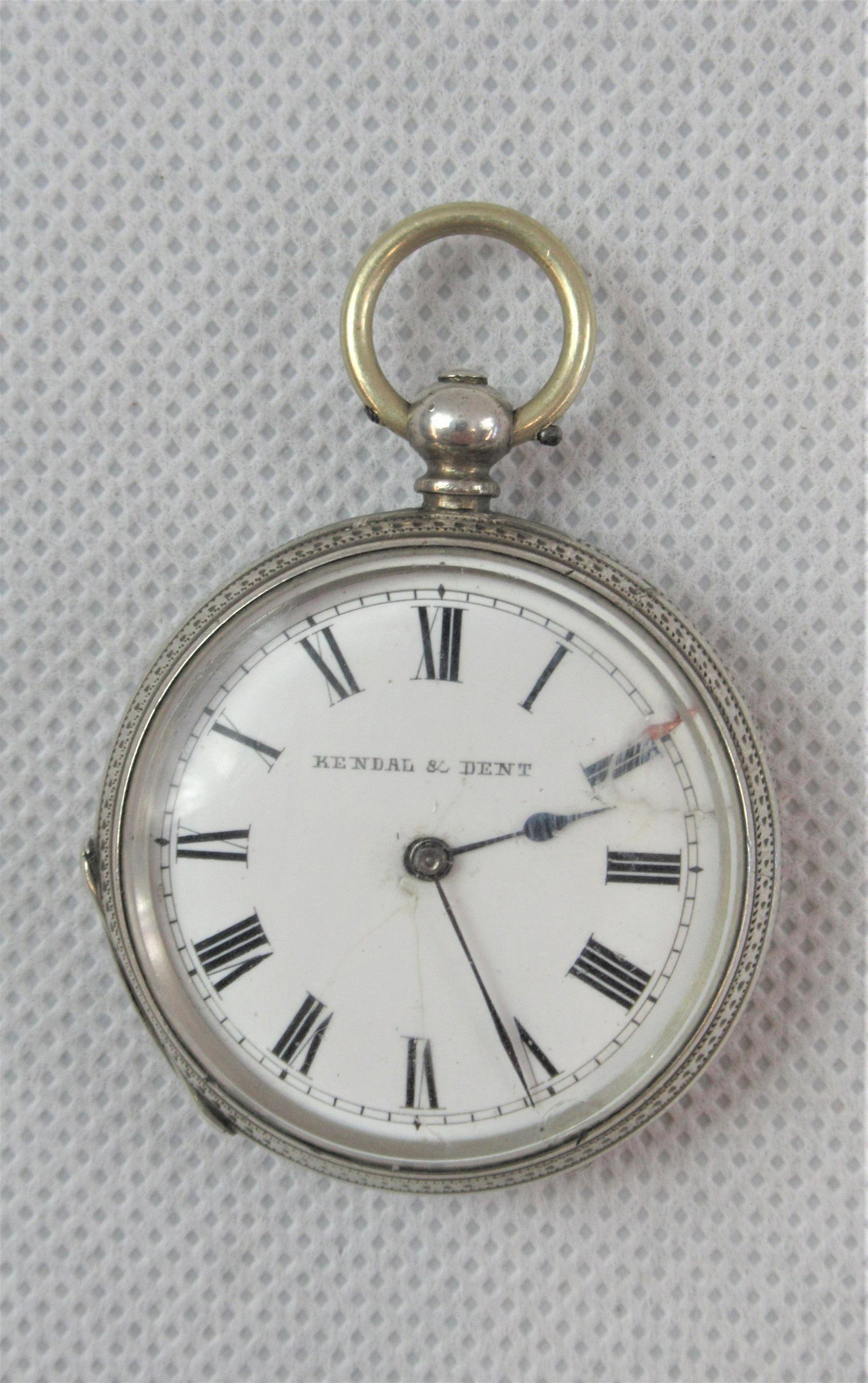 A Silver Cased Pocket Watch: Hallmarked .800 silver case approximately 4cm. 'Kendal & Dent'. Non running (possibly mainspring).
