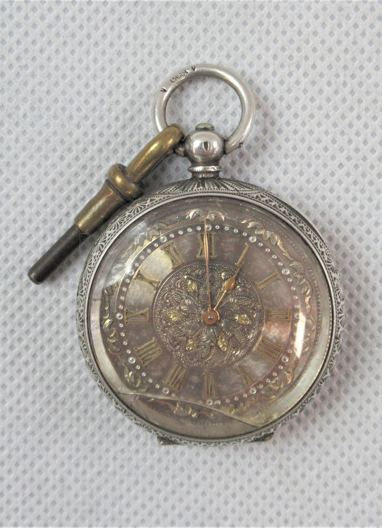 A Silver Cased Pocket Watch: Hallmarked .935 fine silver case approximately 3.8cm. With key. Swiss movement non running (possibly mainspring).